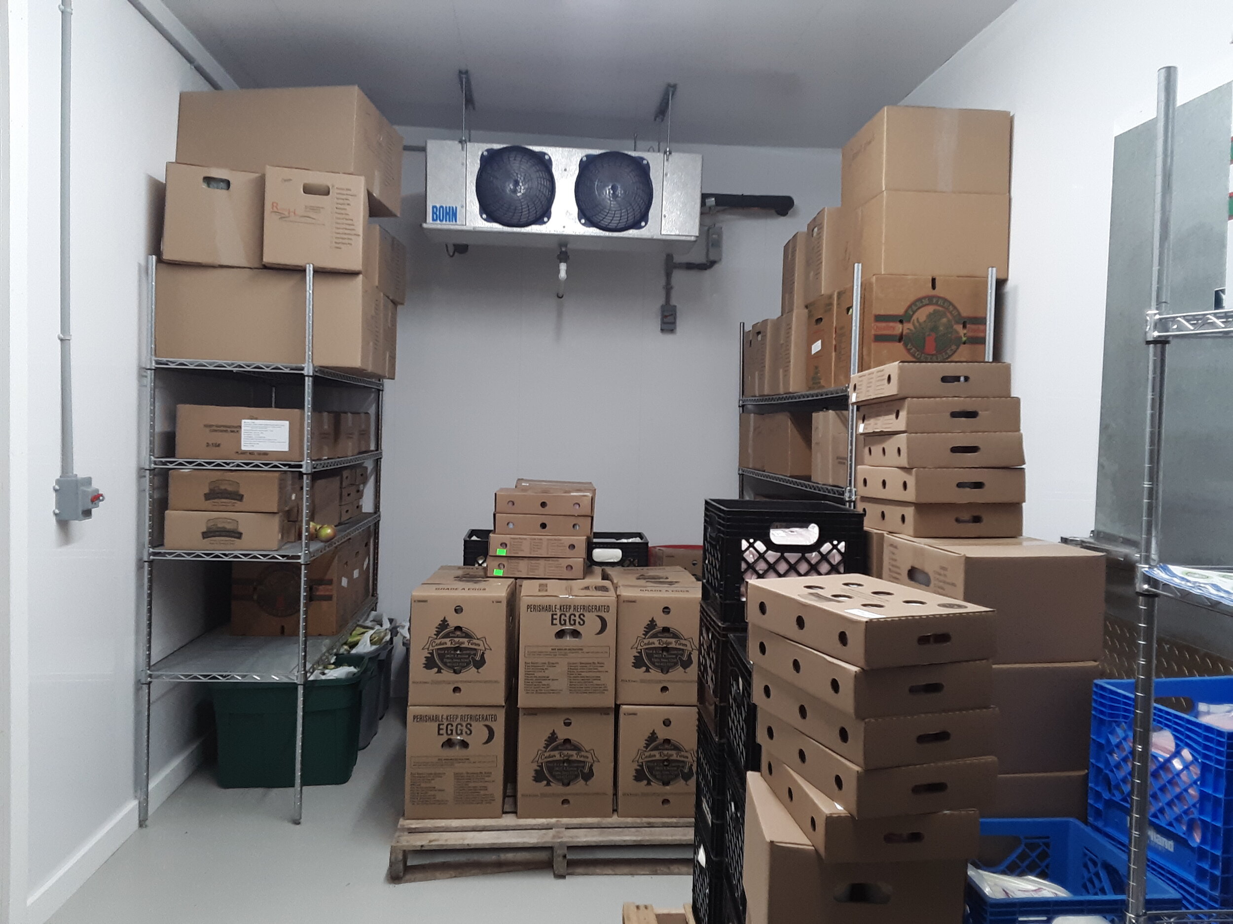 walk-in cooler full of boxes of food