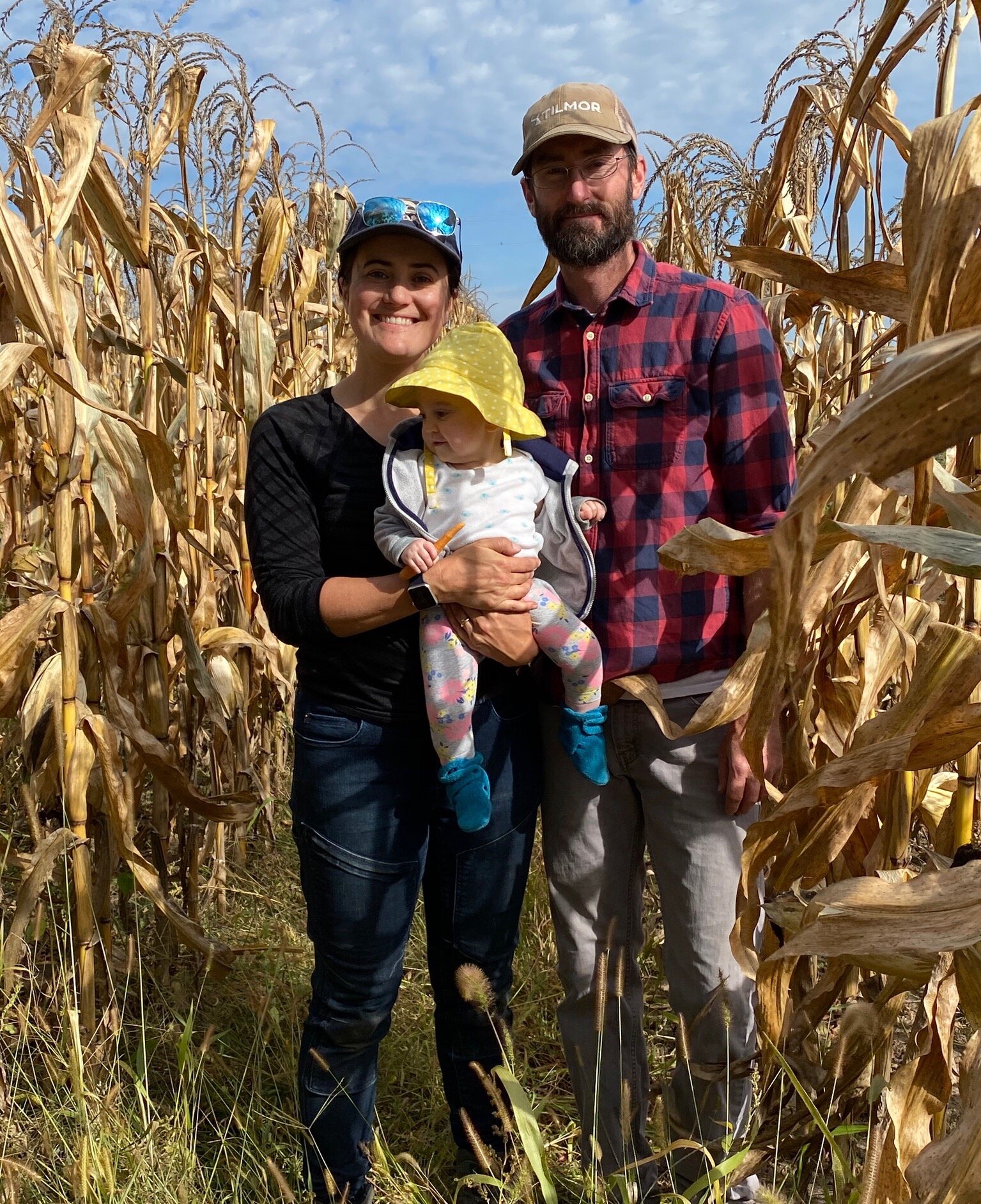 family standing in cornfield