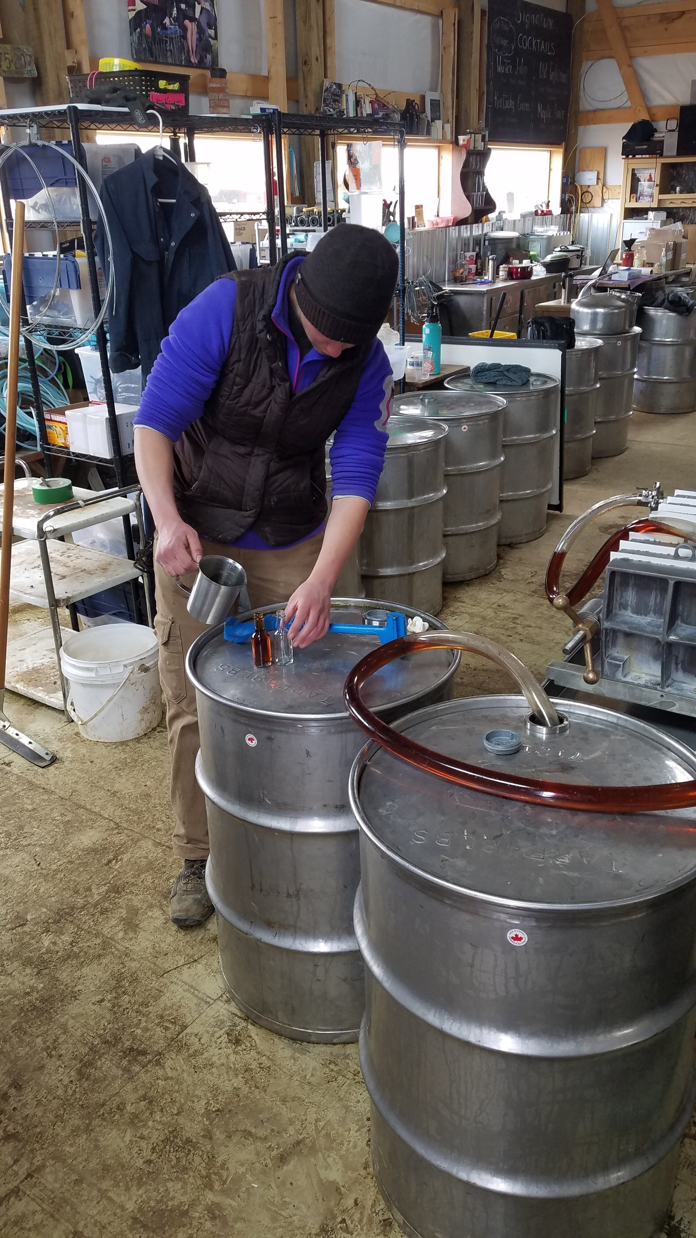 man and keg of maple syrup