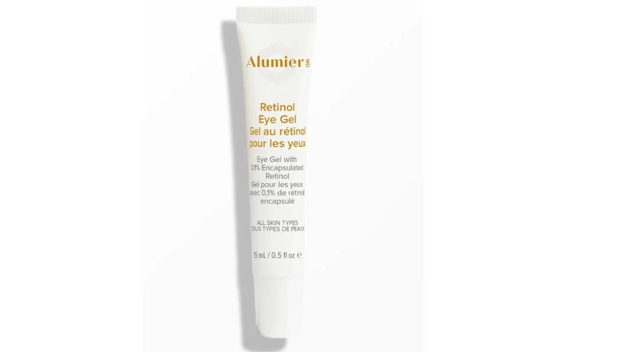 AlumierMD Retinol Eye Gel tube in white and gold packaging on a light background.