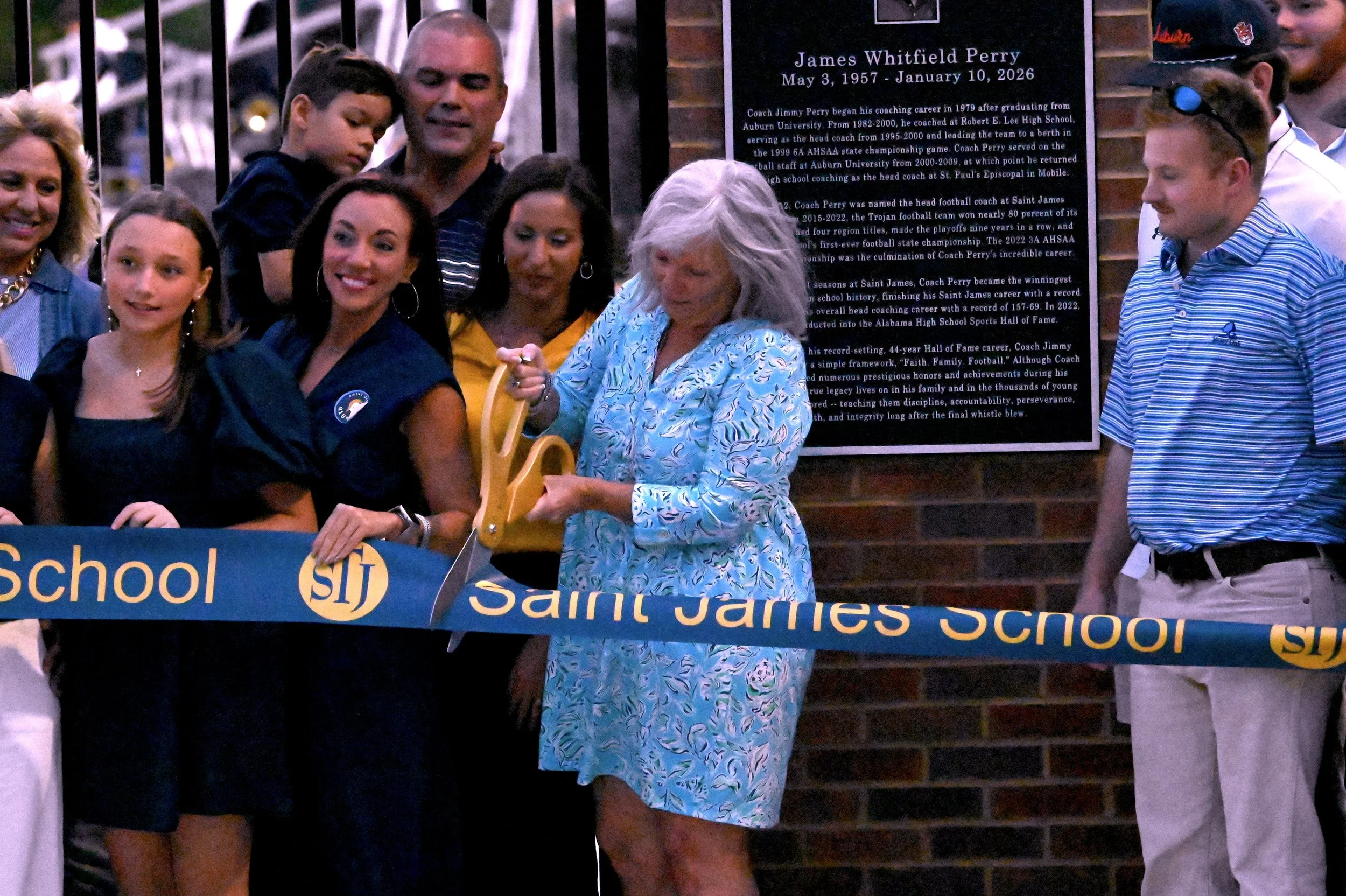 Perry family looks on as Judy cuts the ribbon.JPG