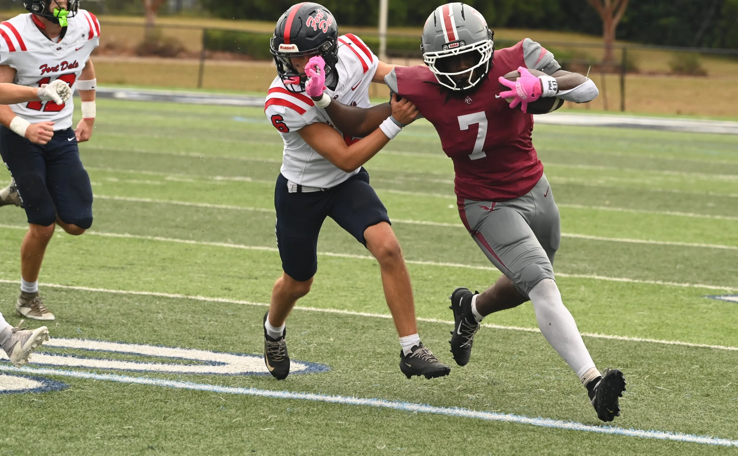 ACA Micah Merritt stiff-arms FD Costner Simmons.JPG