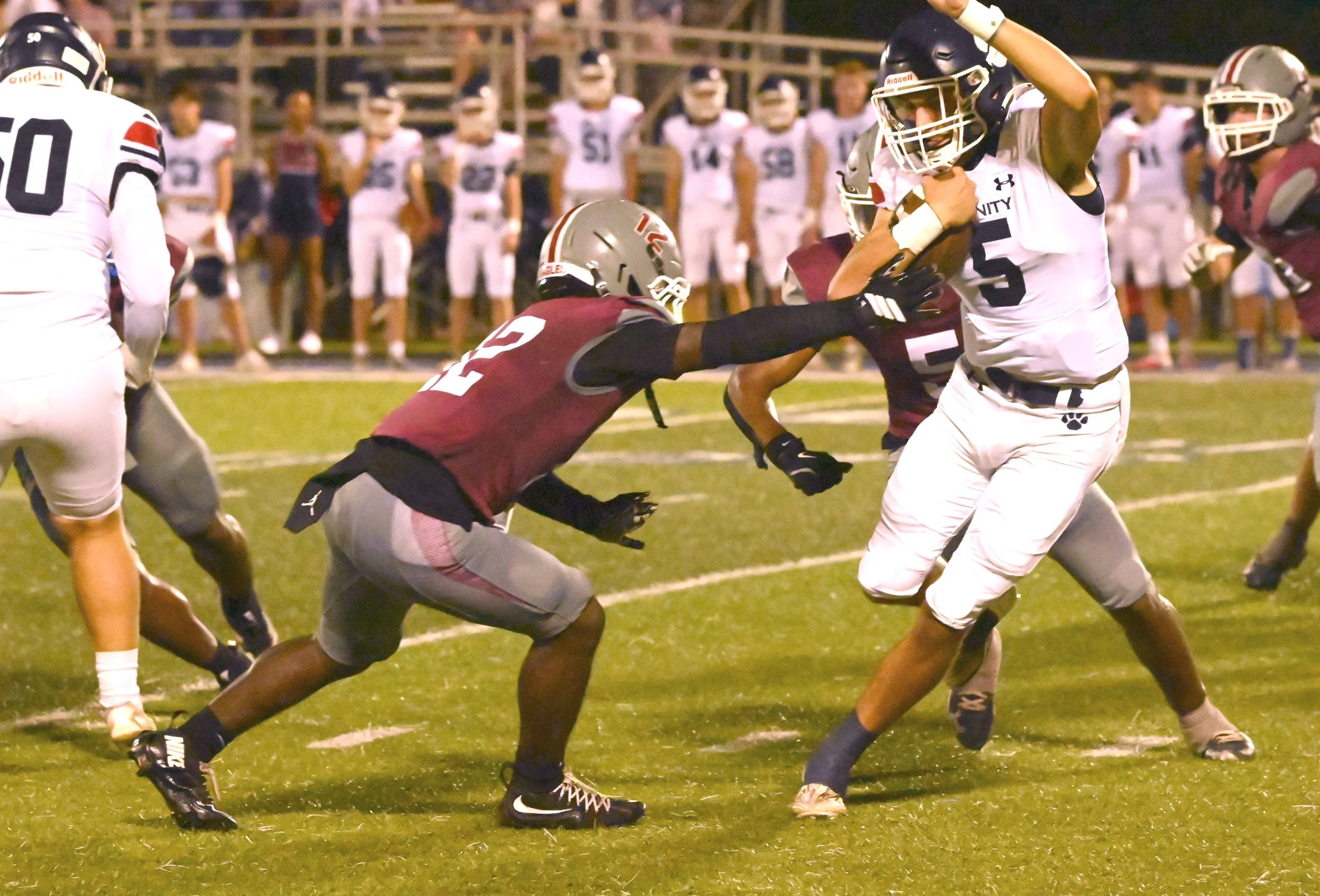 Trin QB Patton Mitchell tries to avoid ACA Bryson Dabney.JPG