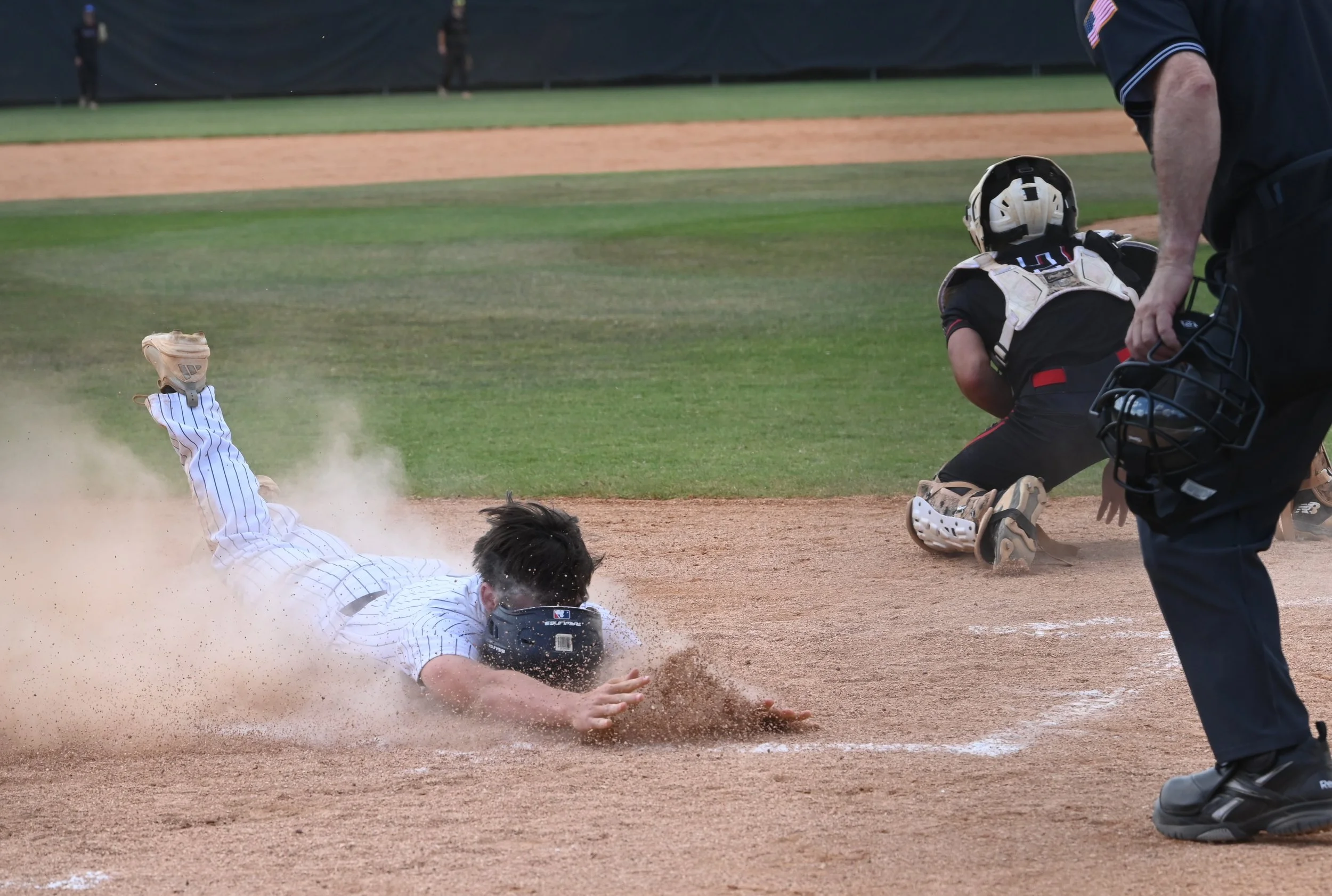 Trin Reed Bledsoe loses helmet on slide home.JPG
