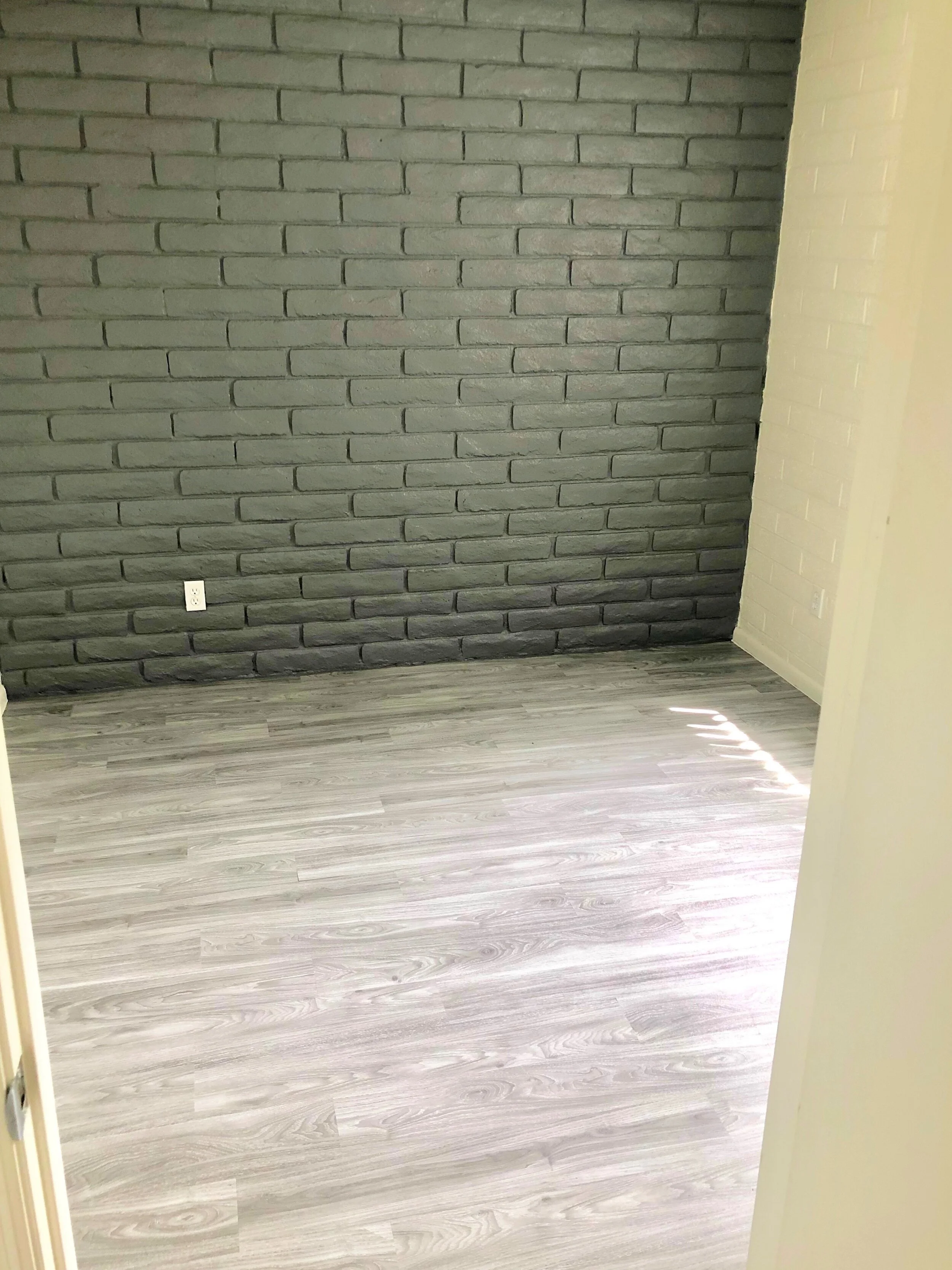  A stylish exposed brick accent wall at our two bedroom two bathroom apartment at University Pointe. 