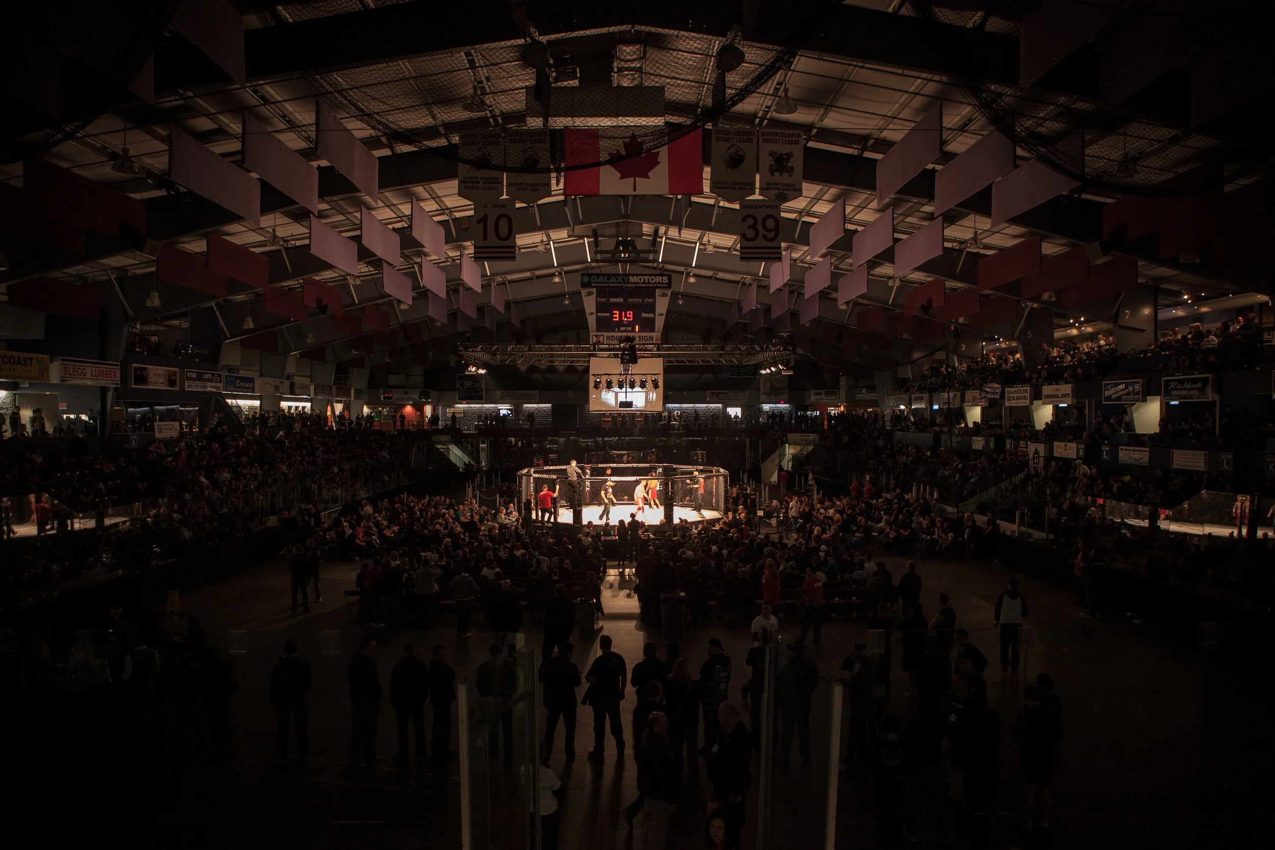  MMA fighters compete for a large crowd. 