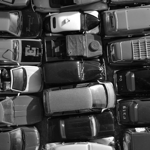 Cars stacked close together in a yard.