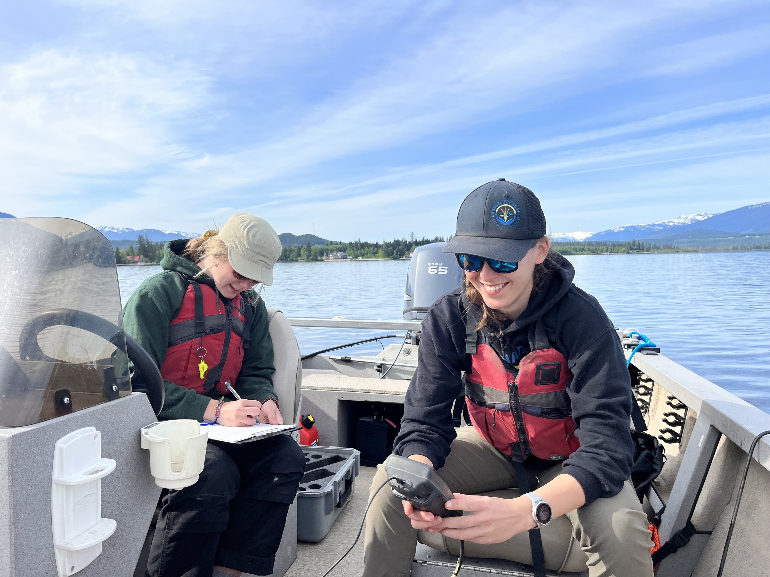 Sampling the water quality of the lake from the boat.
