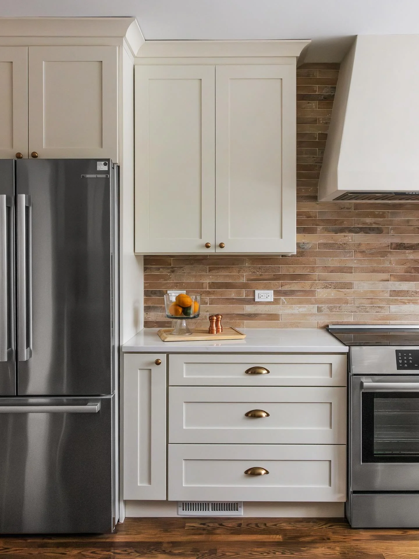 Soft, timeless, and quietly full of character.

This kitchen pairs off-white cabinetry with a brick backsplash that adds just the right amount of warmth and texture. The contrast feels effortless&mdash;clean and refined, yet grounded and inviting.

I