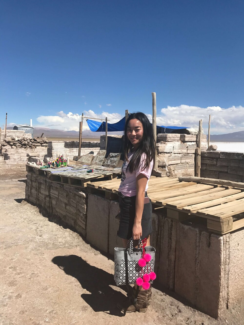 girl-with-colorful-bag-salt-flats-in-distance