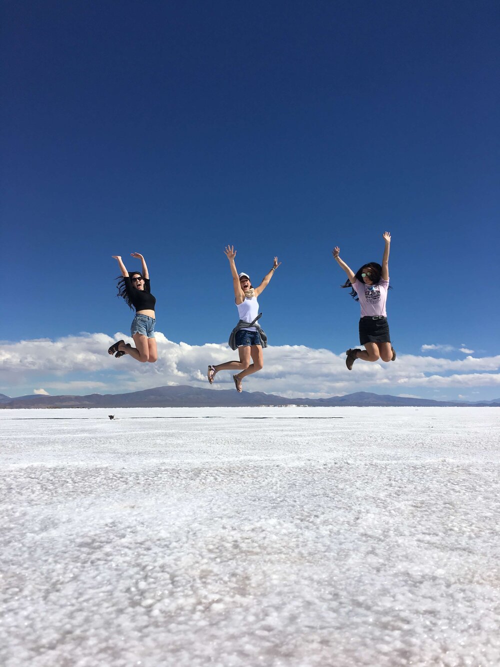 girls-jumping-on-salt-flats-argentina