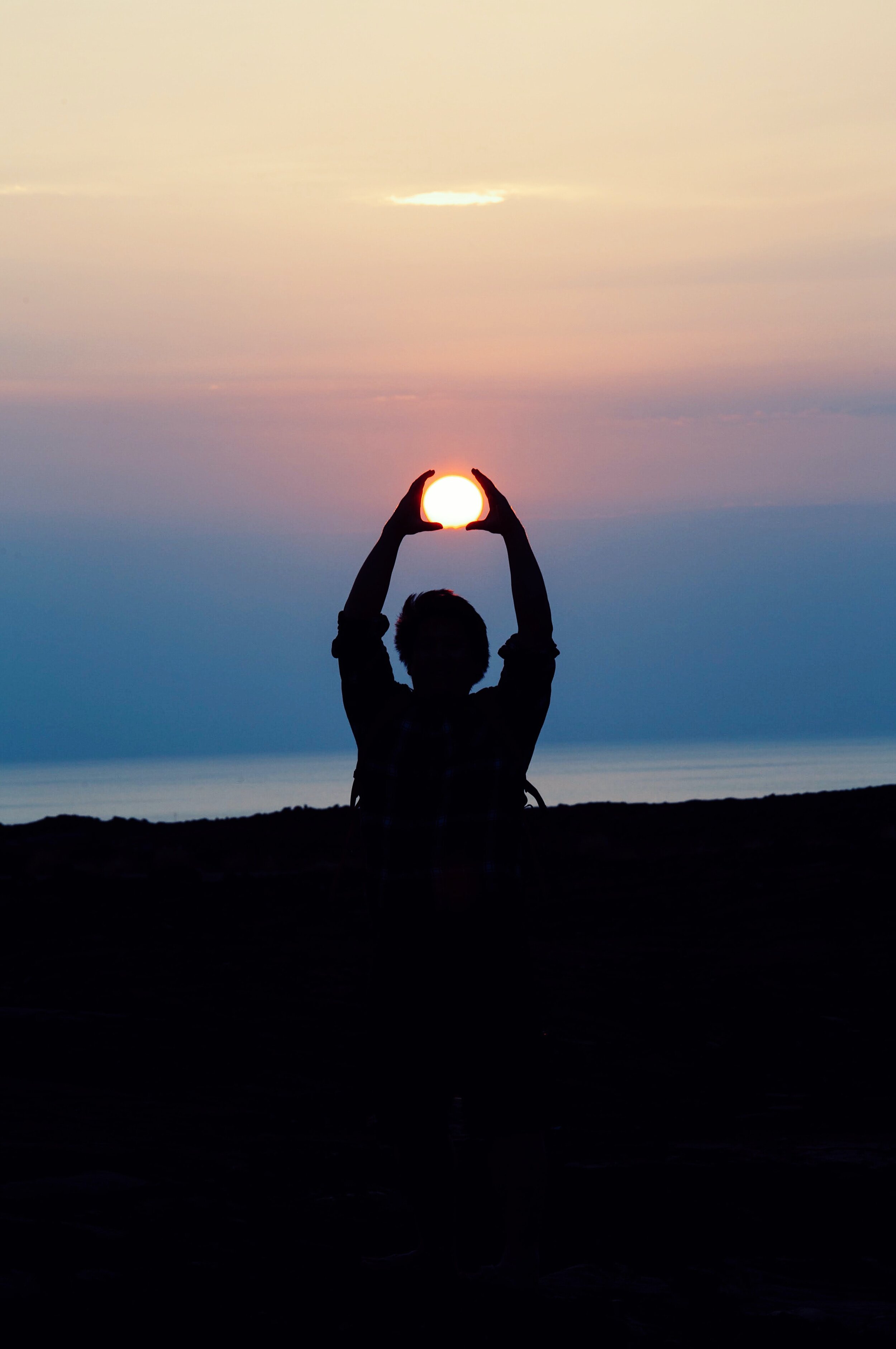 Woman doing yoga at sunset
