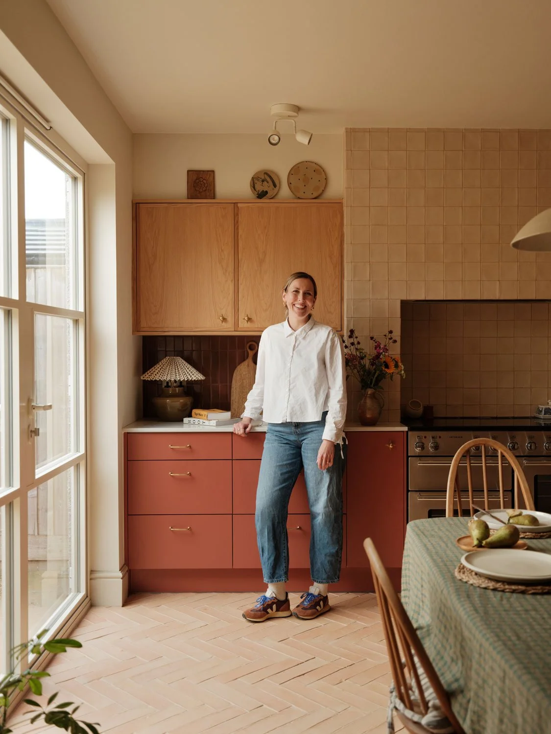 A shot of Studio Rey founder Grace in her contemporary KITCHEN IN Knowle, Bristol