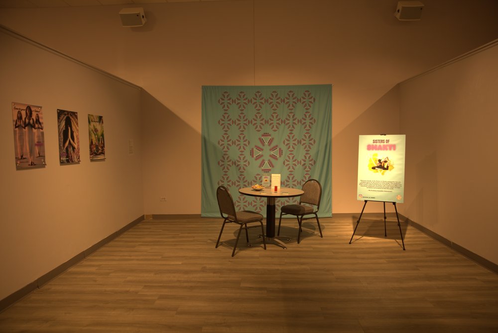 Sisters of Shakti, Site-specific interactive installation, table with postcards, stamp and a bowl of lollipops, 2 chairs, poster on signboard (2021) by Shelly Bahl .jpg