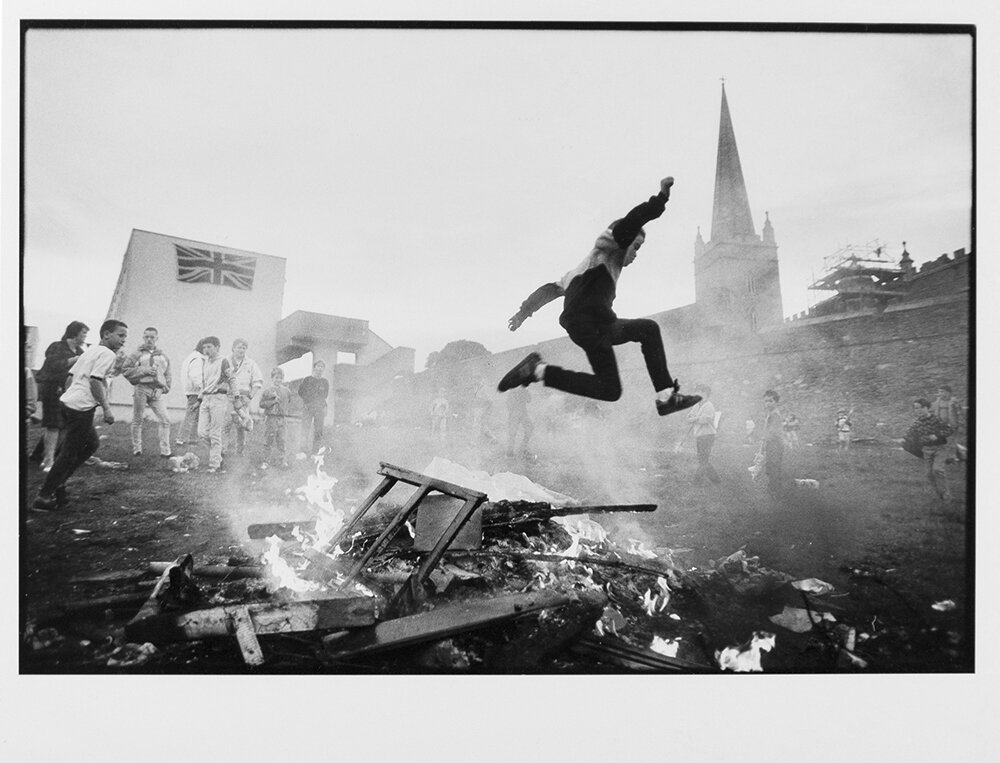  Children play around an impromptu bonfire in The Fountain, a Loyalist housing estate in Londonderry, Northern Ireland. 1989 