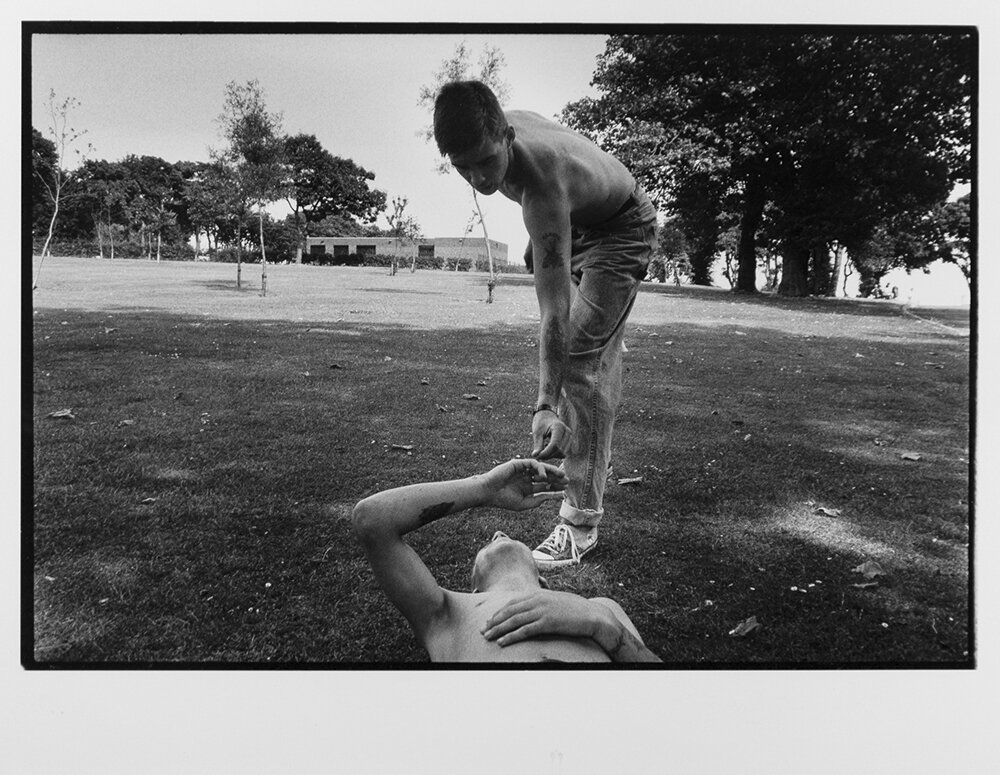  Teenagers from Tiger's Bay share a smoke during a hot summer day in Belfast, Northern Ireland. 1989 