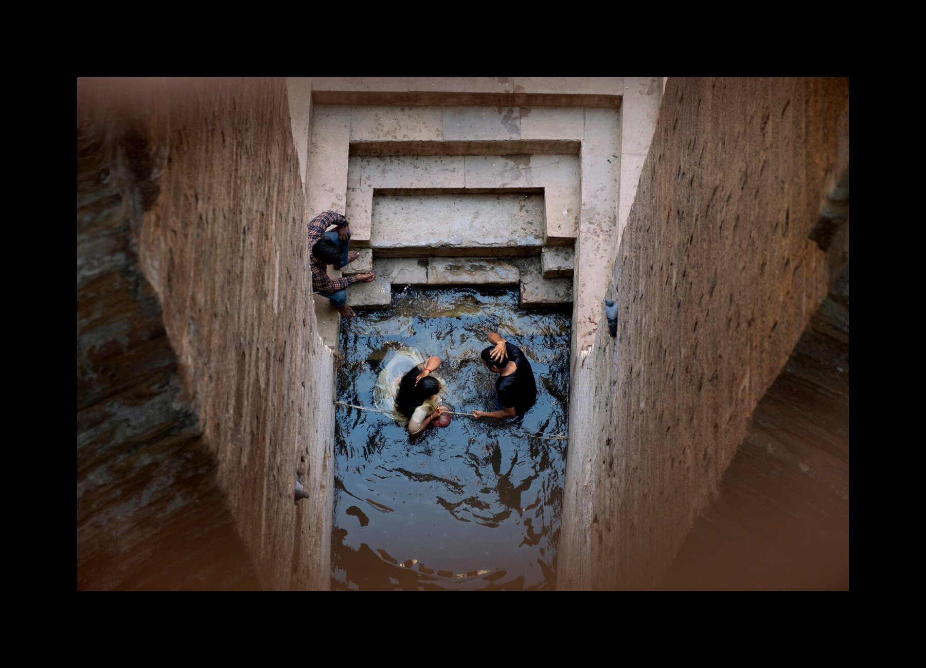  A couple trying to get pregnant bathes in the waters of the Lolark Kund, a sun reservoir believed to be created by a meteor, in Varanasi, India. 2019 