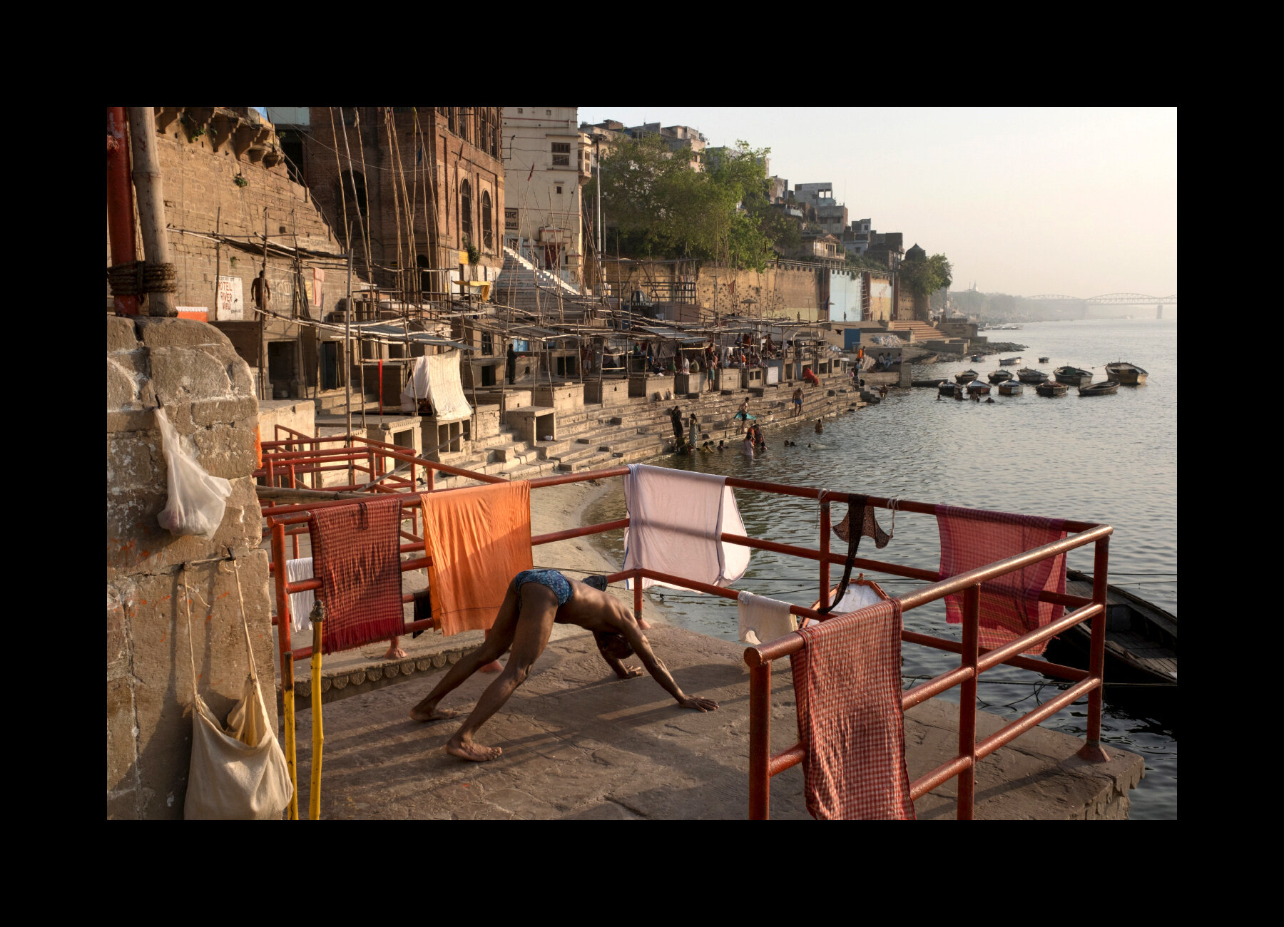  Morning yoga practice along the Ganges River in the early morning in Varanasi, India. 2019 