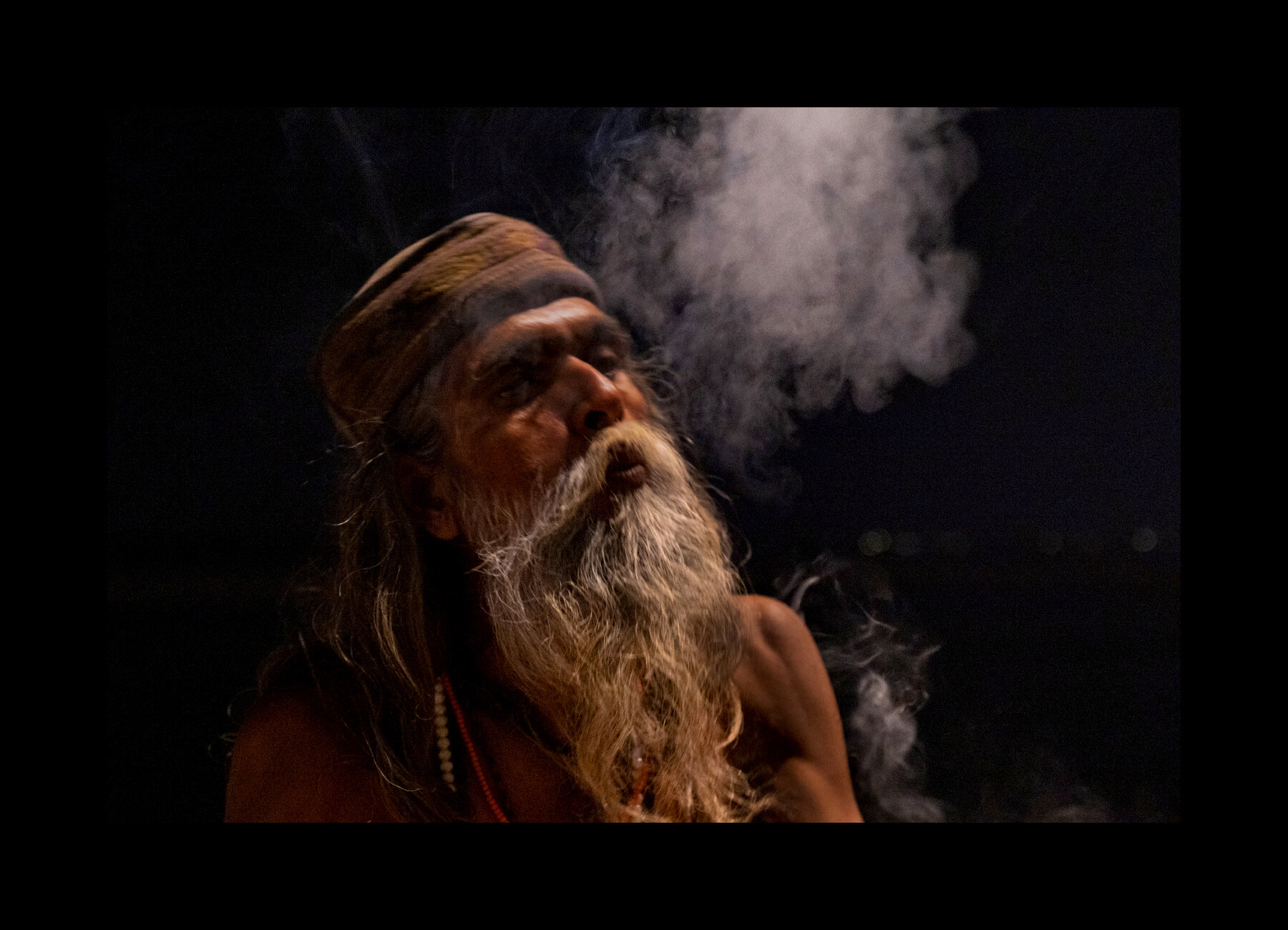  Ashutosh Pandey, a Sadhu, smokes weed on a ghat in Varanasi, India. 2019 