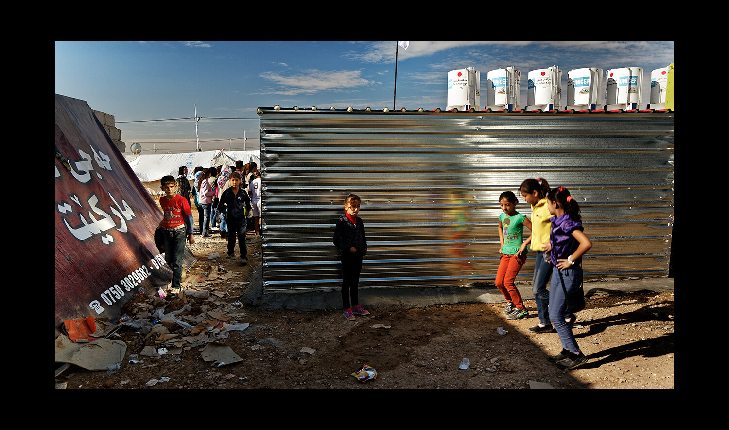  Young girls practice a dance together at the Domiz Refugee camp for Syrians, located just outside of Dohuk, Iraq. 2013 