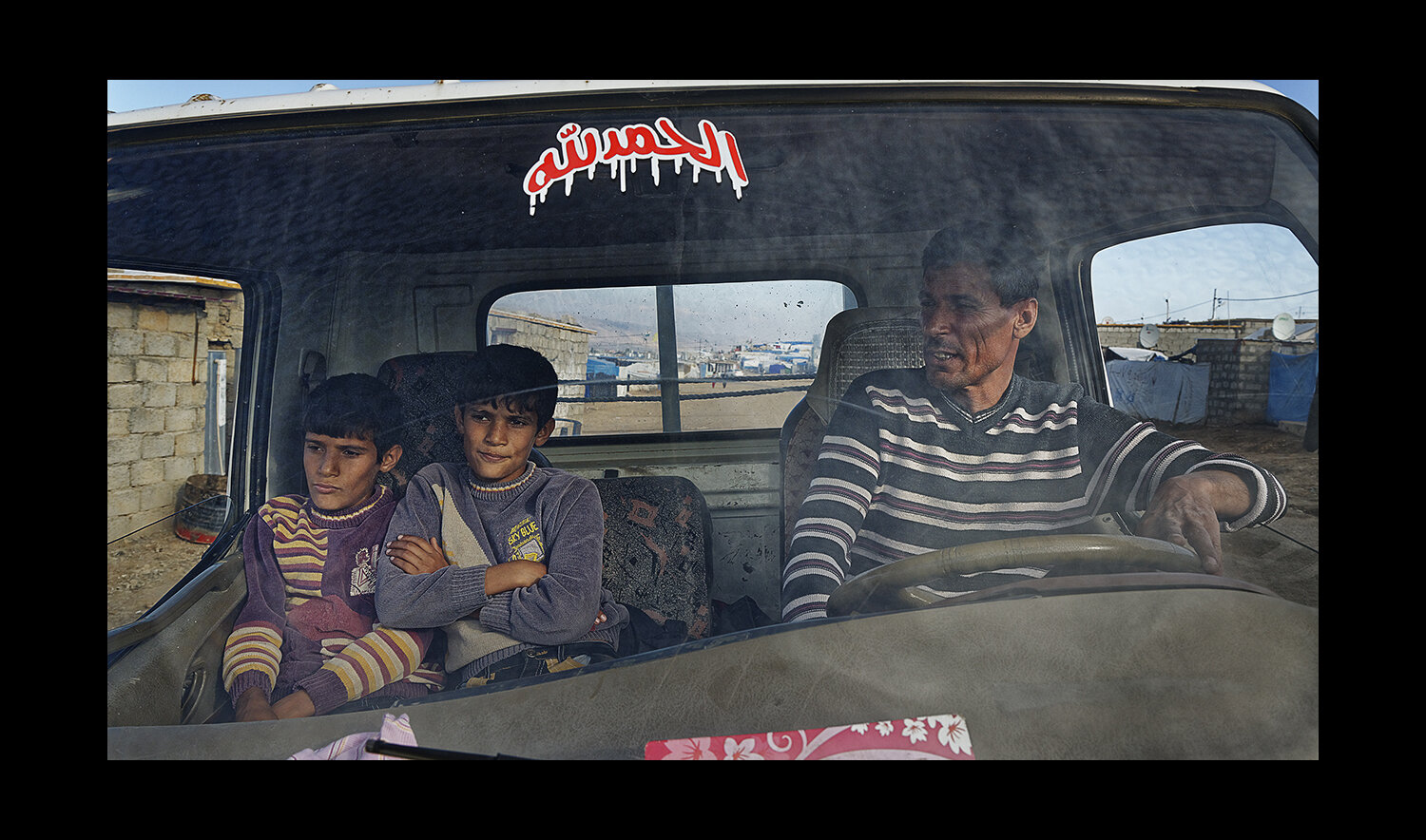  A refugee family squeezes into a car at the Domiz Camp for Syrian Refugees just outside of Dohuk, Iraq. 2013 
