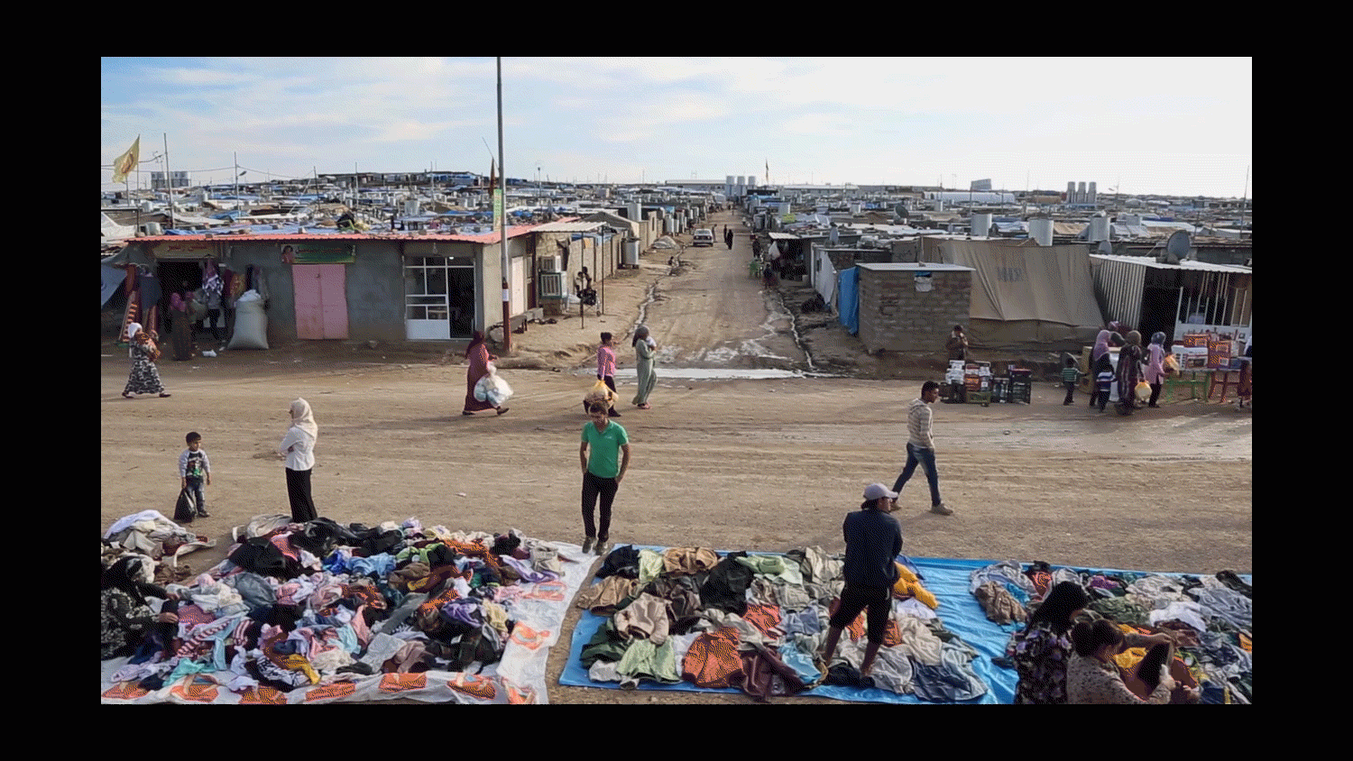  Refugees browse piles of clothing for sale in the Domiz Camp for Syrian Refugees just outside of Dohuk, Iraq. 2013 