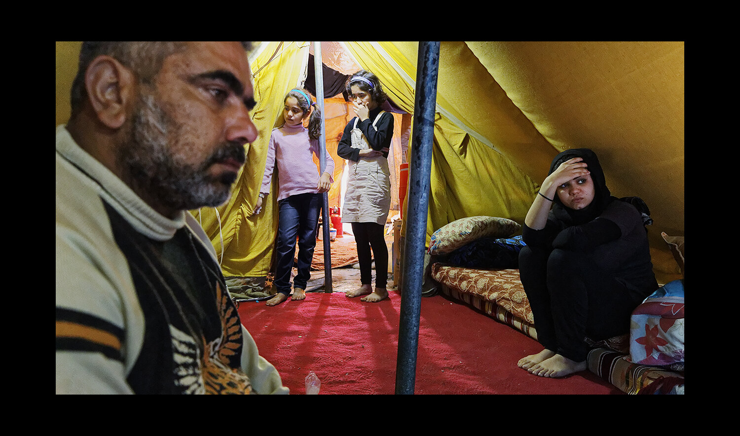  A family sits together in their tent at the Domiz Camp for Syrian Refugees just outside of Dohuk, Iraq. 2013 