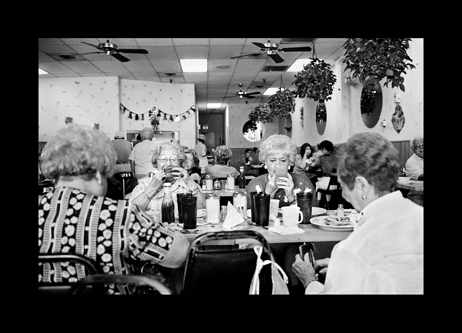  A group of friends check their make-up after a meal in a Coconut Creek bagel shop, Florida. 2001 