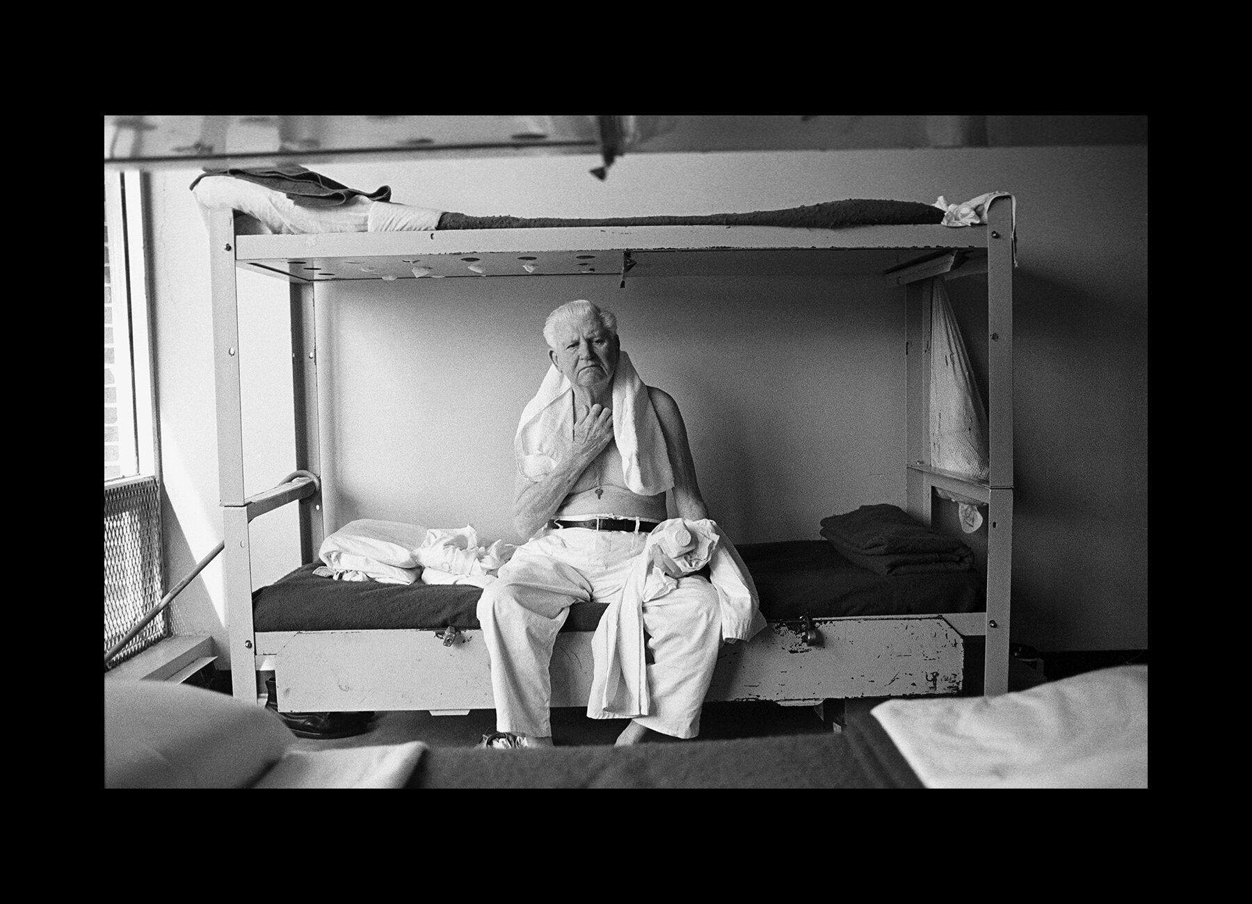  An inmate at the Hamilton Aged and Infirmed facility on his bunkbed, used because of overcrowding. Hamilton, Alabama. 1997 