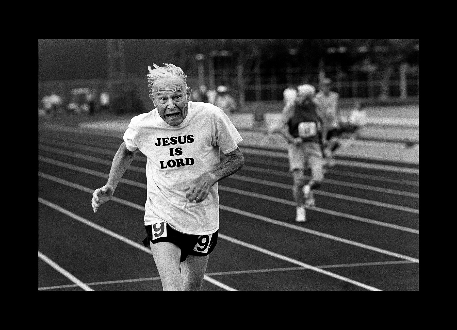  A sprinter crosses the finish line during a track event at the Senior Olympics in Baton Rouge, Louisiana. 2001 