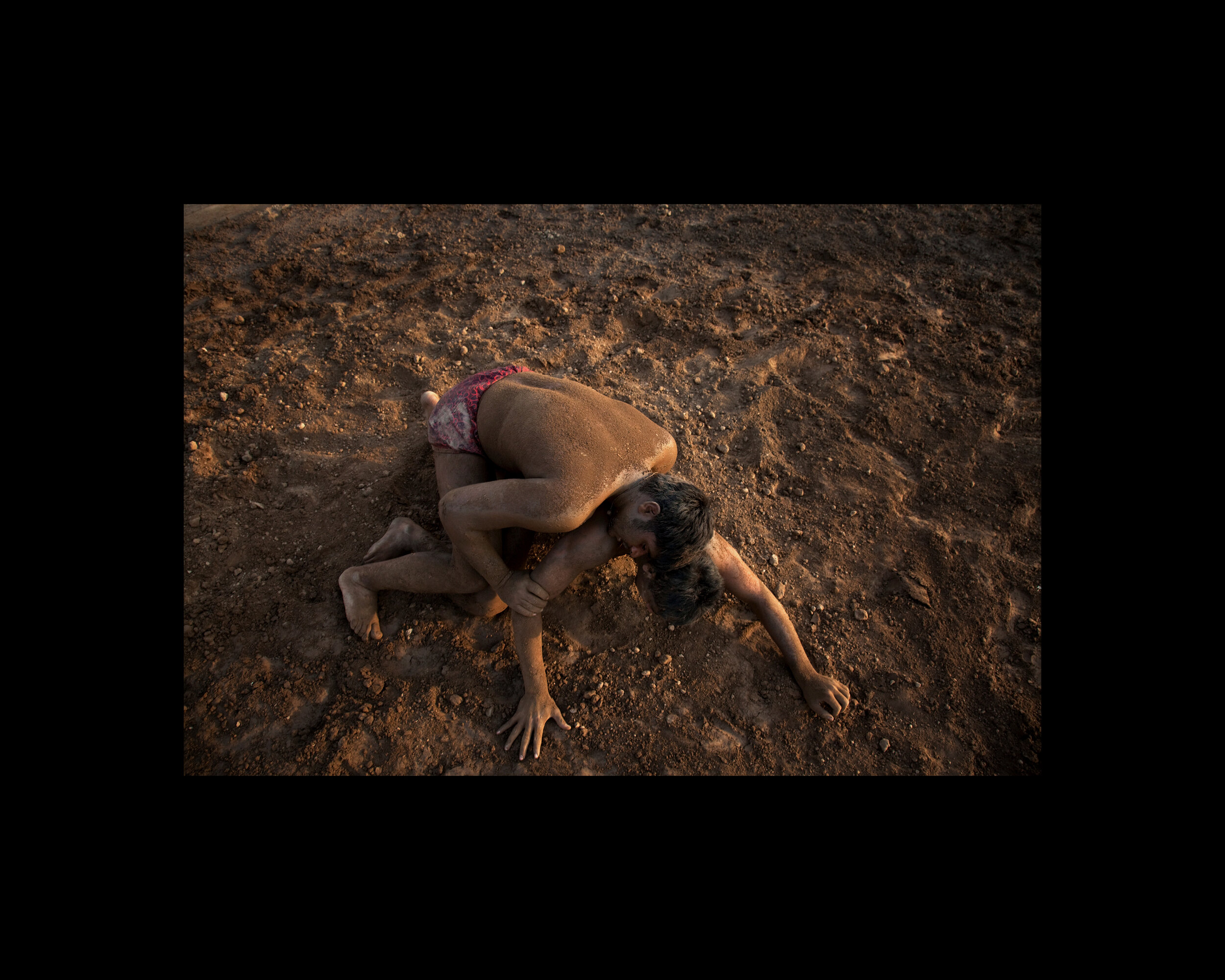  Combatants grapple in the dirt during Kushti, or Pehlwani, a martial art and style of wrestling popular in India, Pakistan, and Bangladesh. Punjab, Pakistan. 2009 