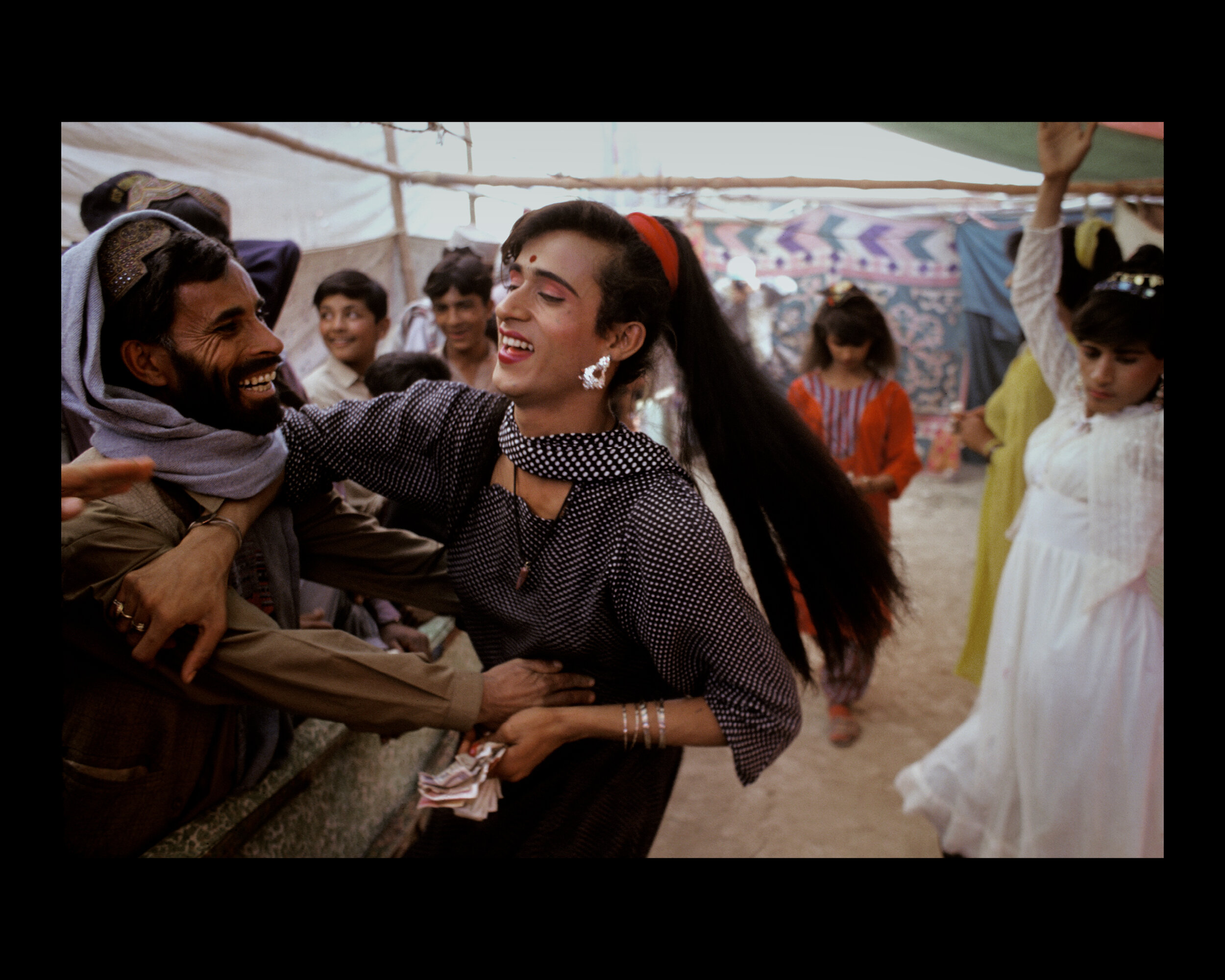  A trans person and onlooker are playful at the Sibi Mela Camel Festival in Balochistan, Pakistan. 1997 