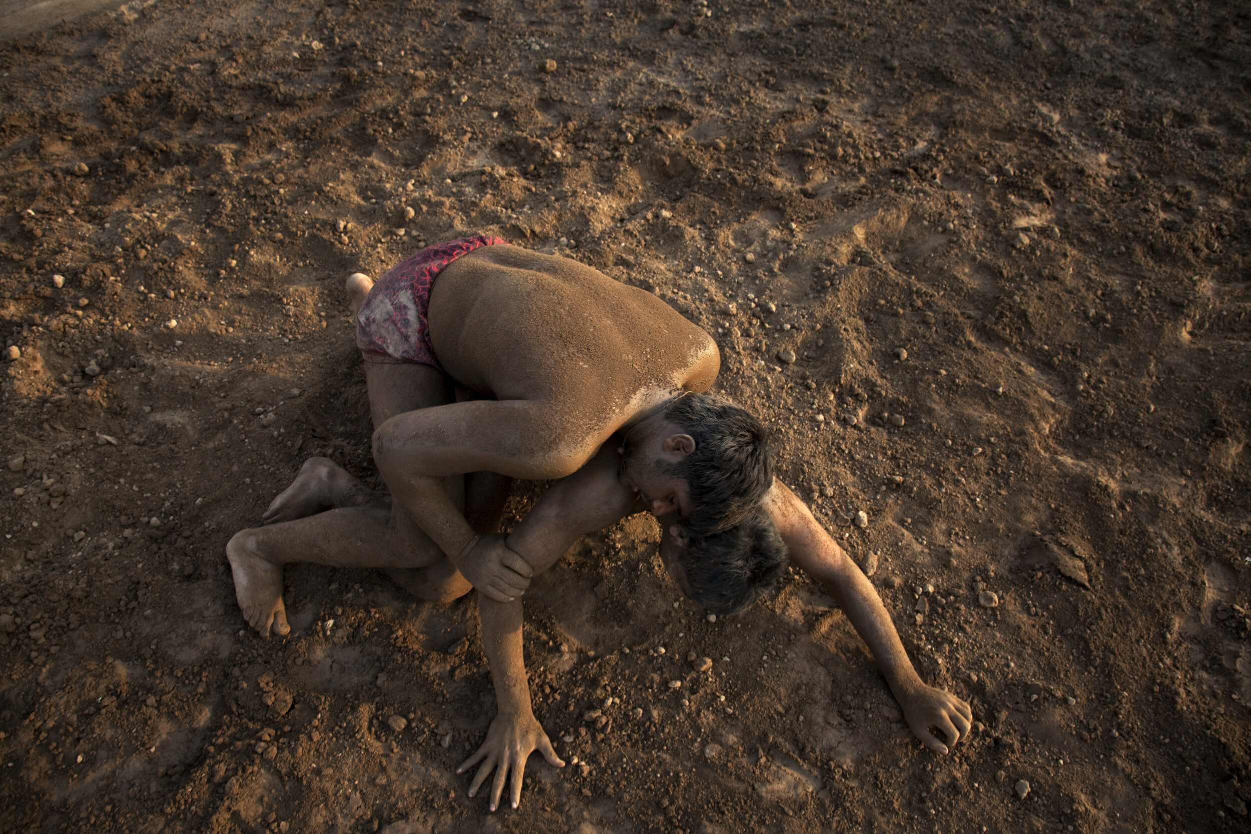  Combatants grapple in the dirt during Kushti, or Pehlwani, a martial art and style of wrestling popular in India, Pakistan, and Bangladesh. Punjab, Pakistan. 2009 