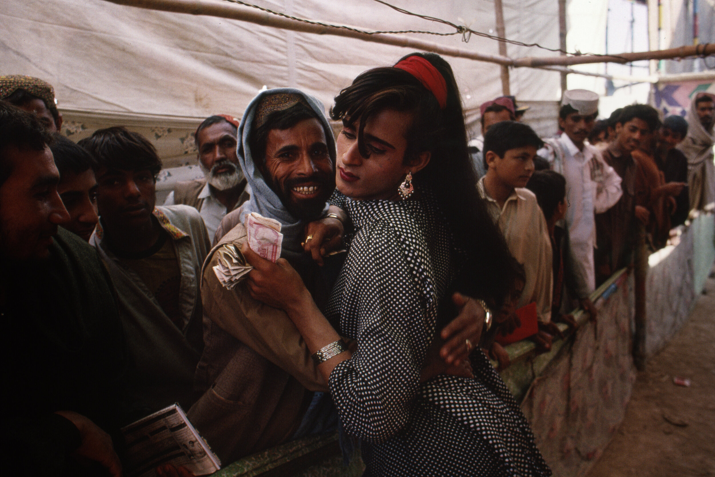  A trans person and onlooker are playful at the Sibi Mela Camel Festival in Balochistan, Pakistan. 1997 