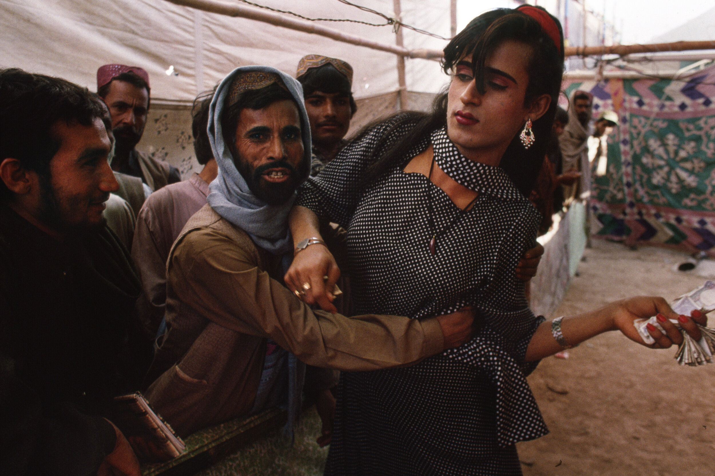  A trans person and onlooker are playful at the Sibi Mela Camel Festival in Balochistan, Pakistan. 1997 