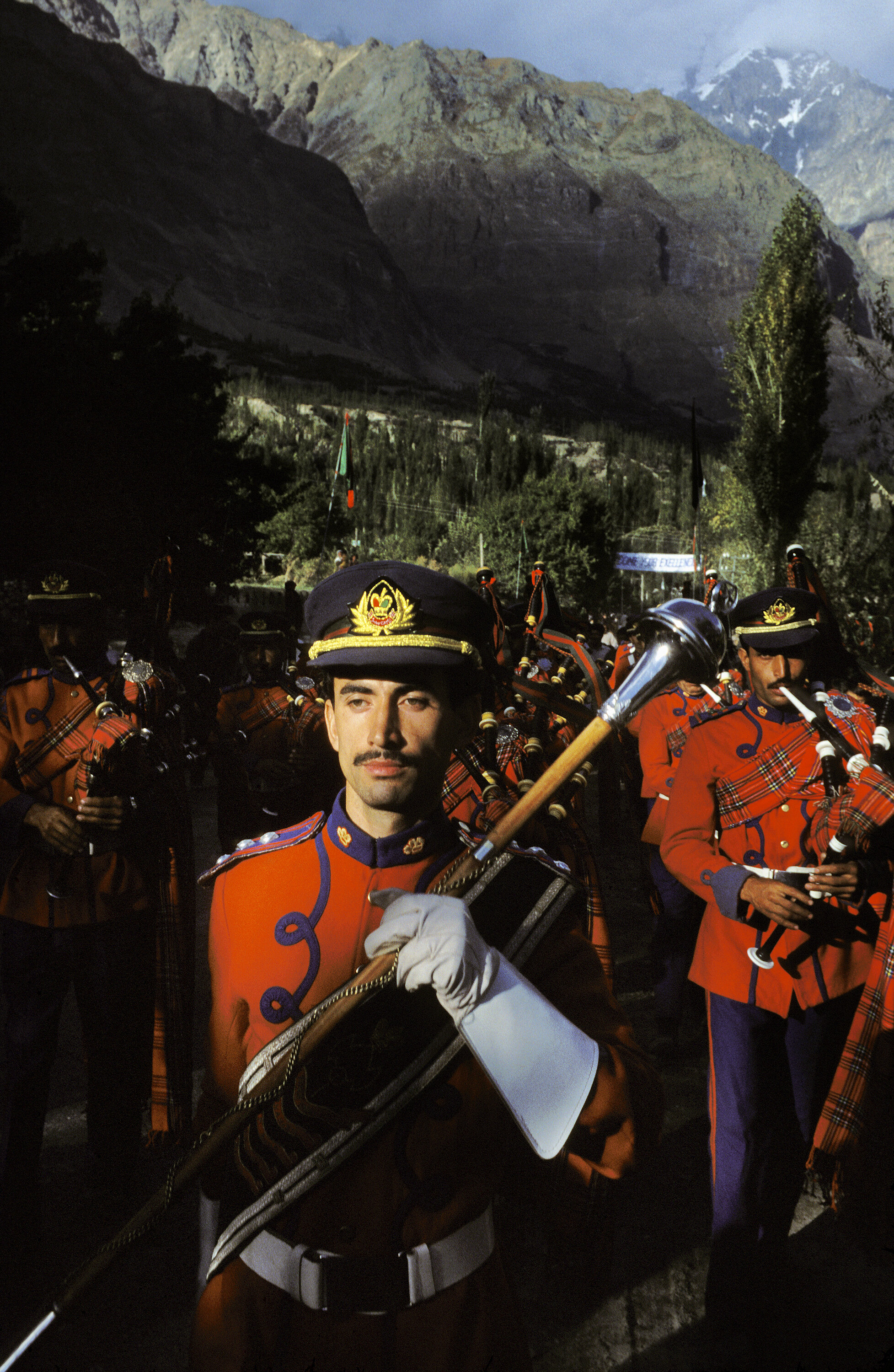  A pipe band marches through Aliabad on the Karakoram Highway in preparation for the Aga Khan’s visit. Pakistan. 1998 