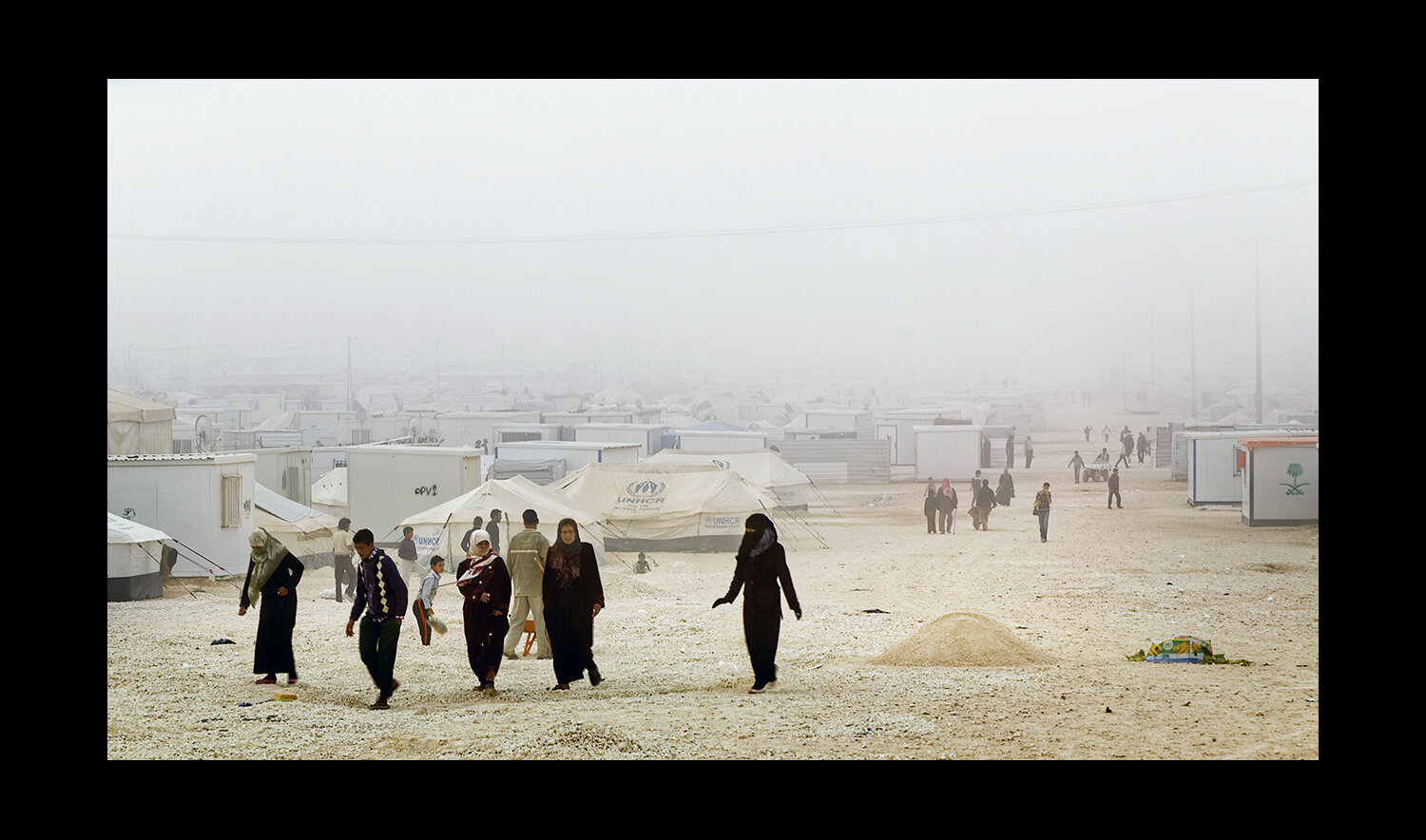  Refugees walk together through the overcrowded Al Za'atri refugee camp for Syrians, near Mafraq, Jordan. 2013 