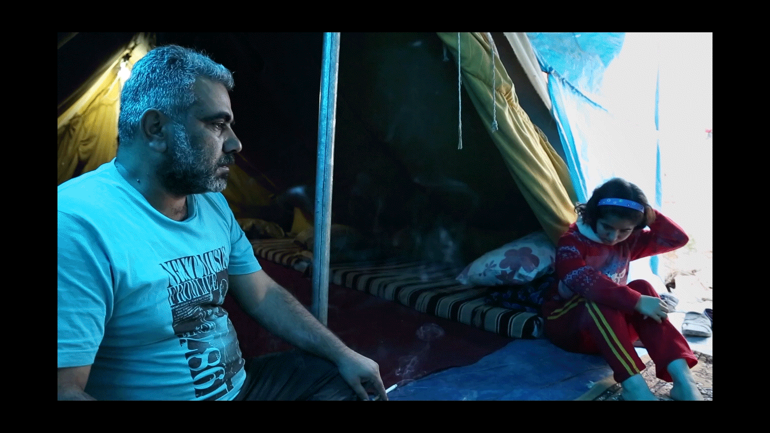  Father and daughter in their tent in the Domiz Camp for Syrian Refugees near Dohuk, Iraq. Their family fled Damascus, Syria over a year prior. 2013 
