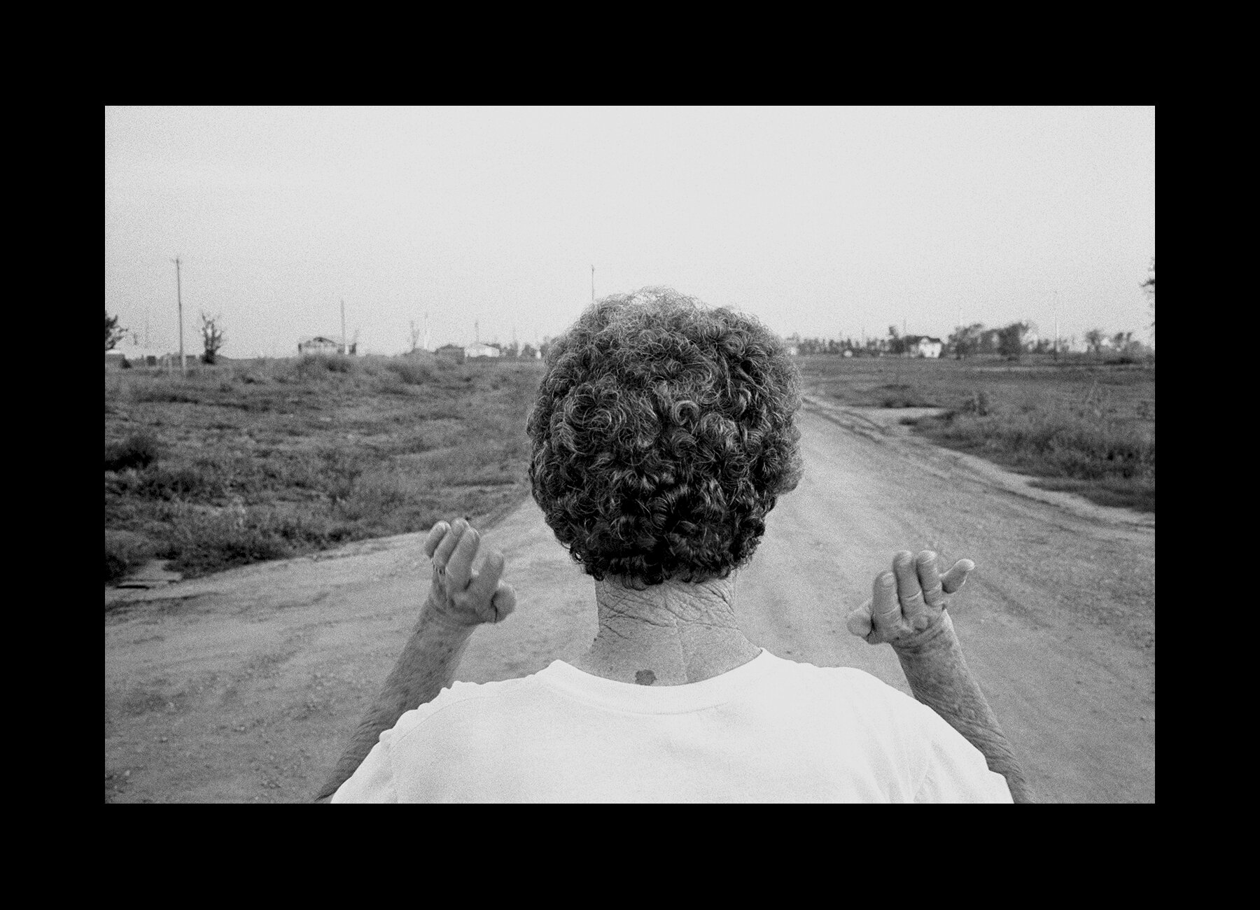  Delphia Stuby, 72, stares down her street after a tornado leveled everything in sight in Spencer, South Dakota. 1998 