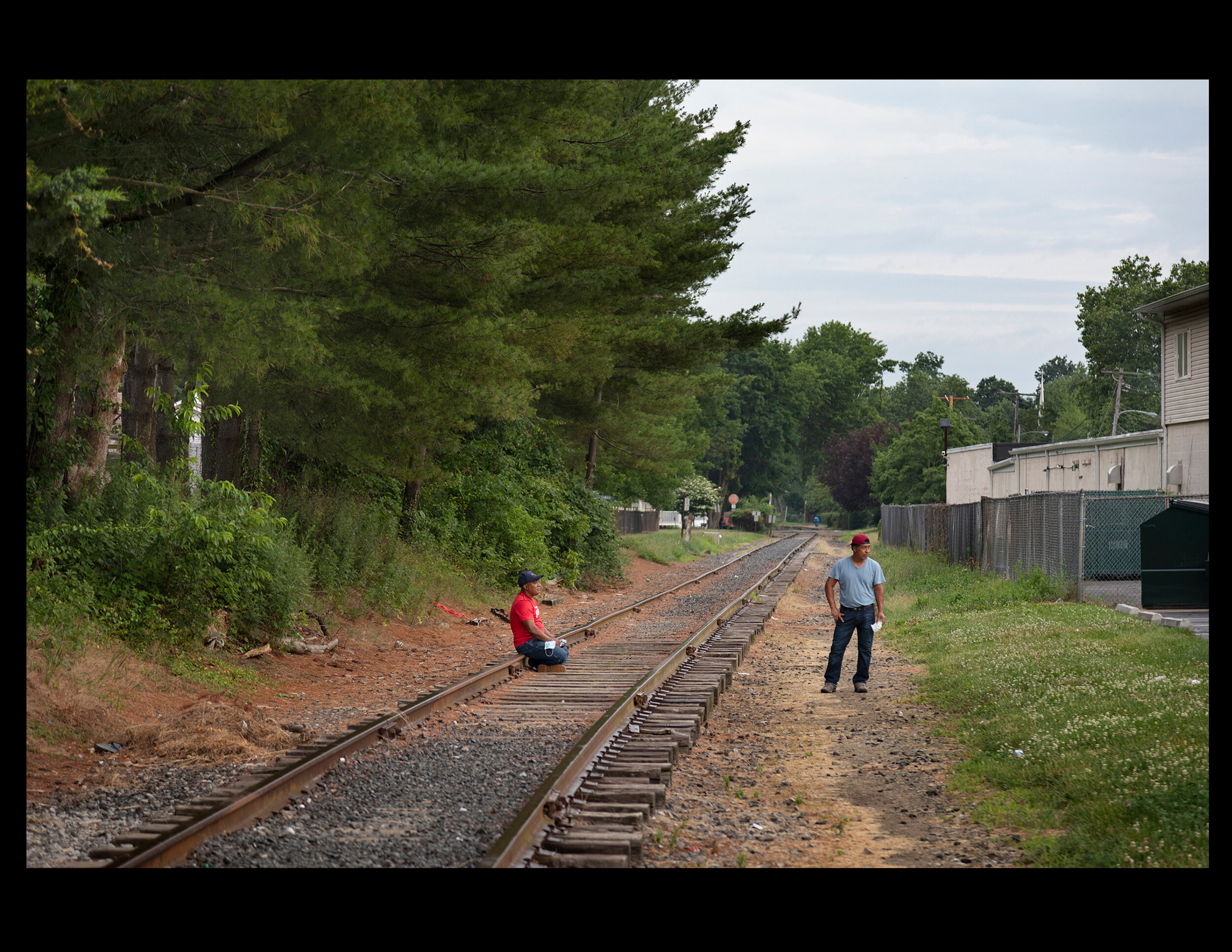  Day laborers wait at the 6 Twelve food store in Freehold, New Jersey on June 26, 2020. 