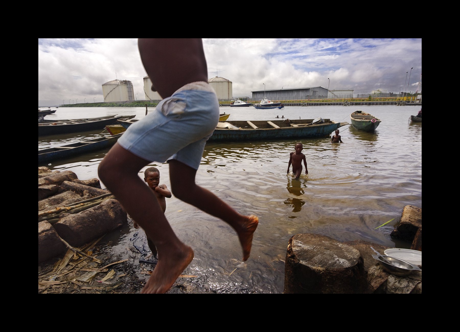   Bonny Island, Niger Delta, 2004       Children play in polluted waters.   