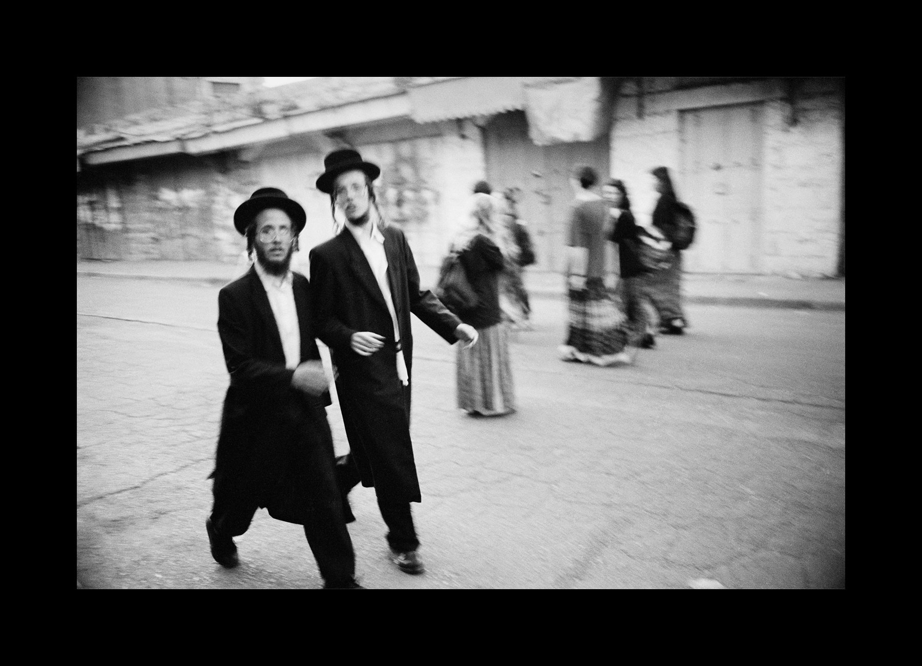    Hebron, Israel, 1995    Visiting Hasidic Jews stroll freely through the Jewish section of Hebron, the contested land in Israel’s West Bank.    