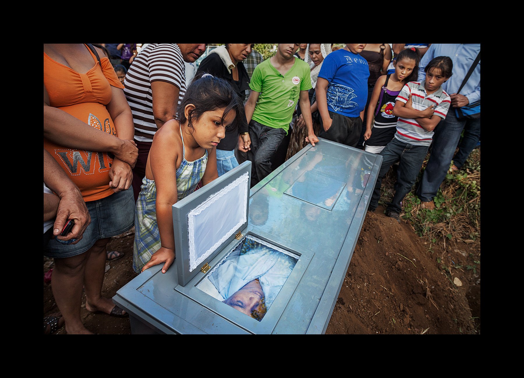  Family and friends gather for the funeral procession and burial of a former sugar cane worker, 36, who died of CKDnT, in Chichigalpa, Nicaragua on Jan. 7, 2013. After working in the sugar cane fields for 12 years, he is part of a steady procession o