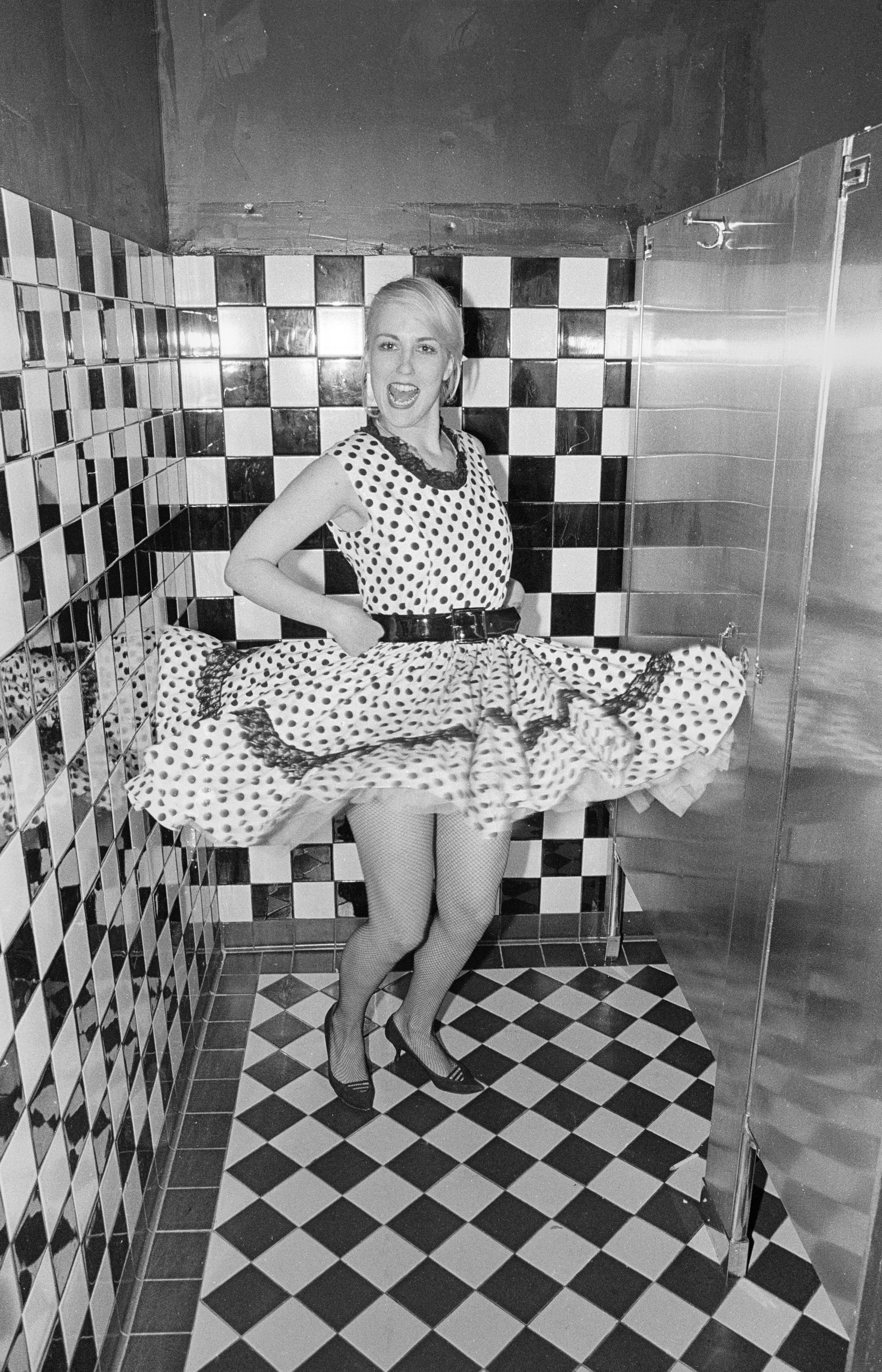  A woman in the post-punk/ new-wave music and fashion scene shows off her dress at a club in Berkeley. 1980 