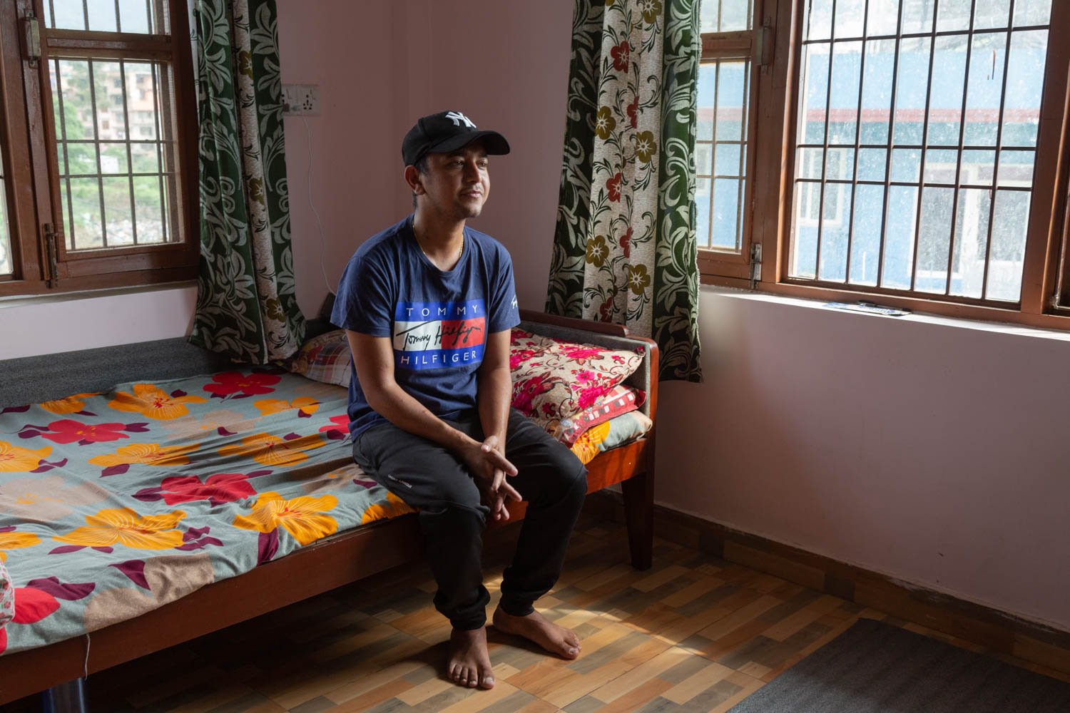  Mahendra Ranabhat, 29, poses on his bed in a rented home in Bhaktapur, Nepal on June 26, 2022.  Ranabhat is living in the Tanahun district in Nepal.  His father, Moti Ram Ranabhat, donated one of his kidneys to his eldest son, who worked in the Gulf