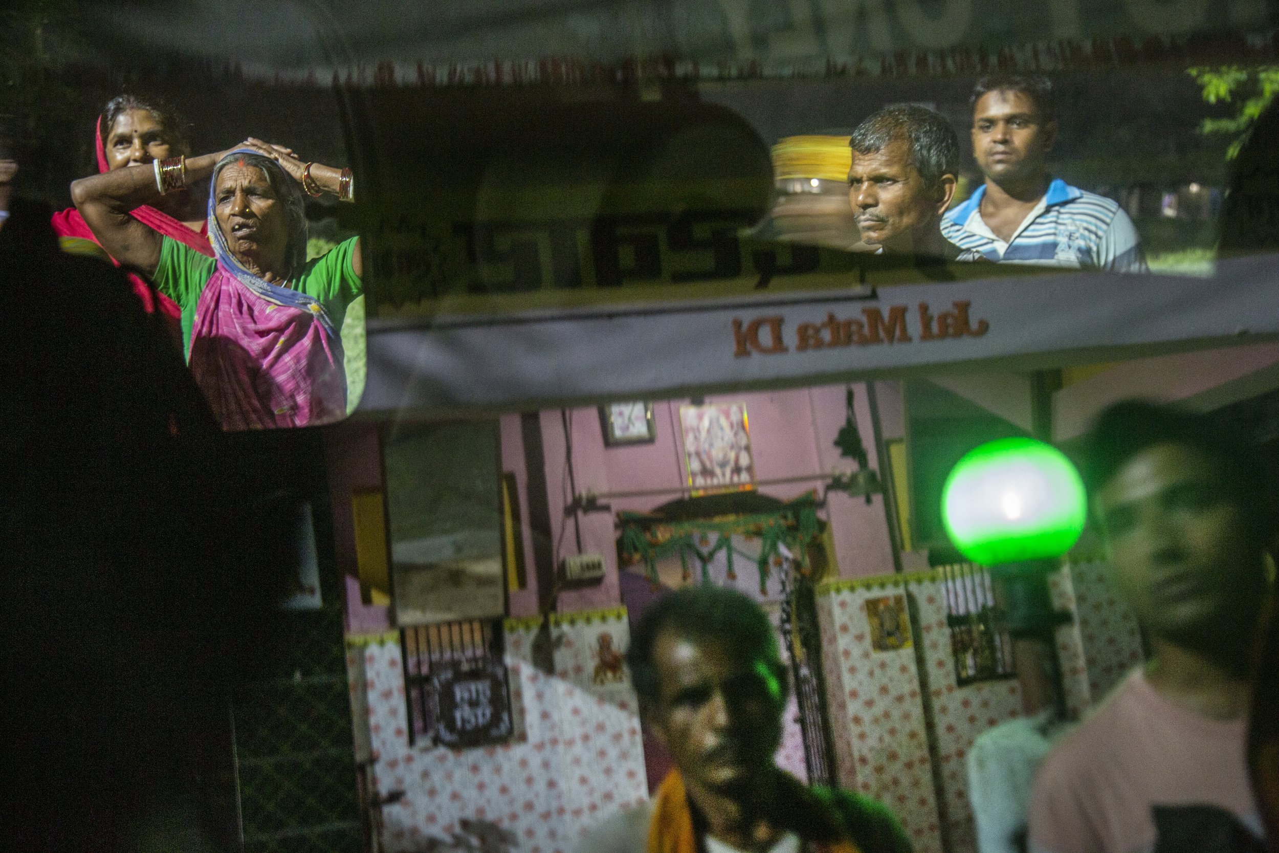  A street scene of car reflections taken at the nightly Hindu ceremony in the village of Nagrain 9, in the Ghodhas District outside of Janakpur, Nepal on July 1, 2022.  