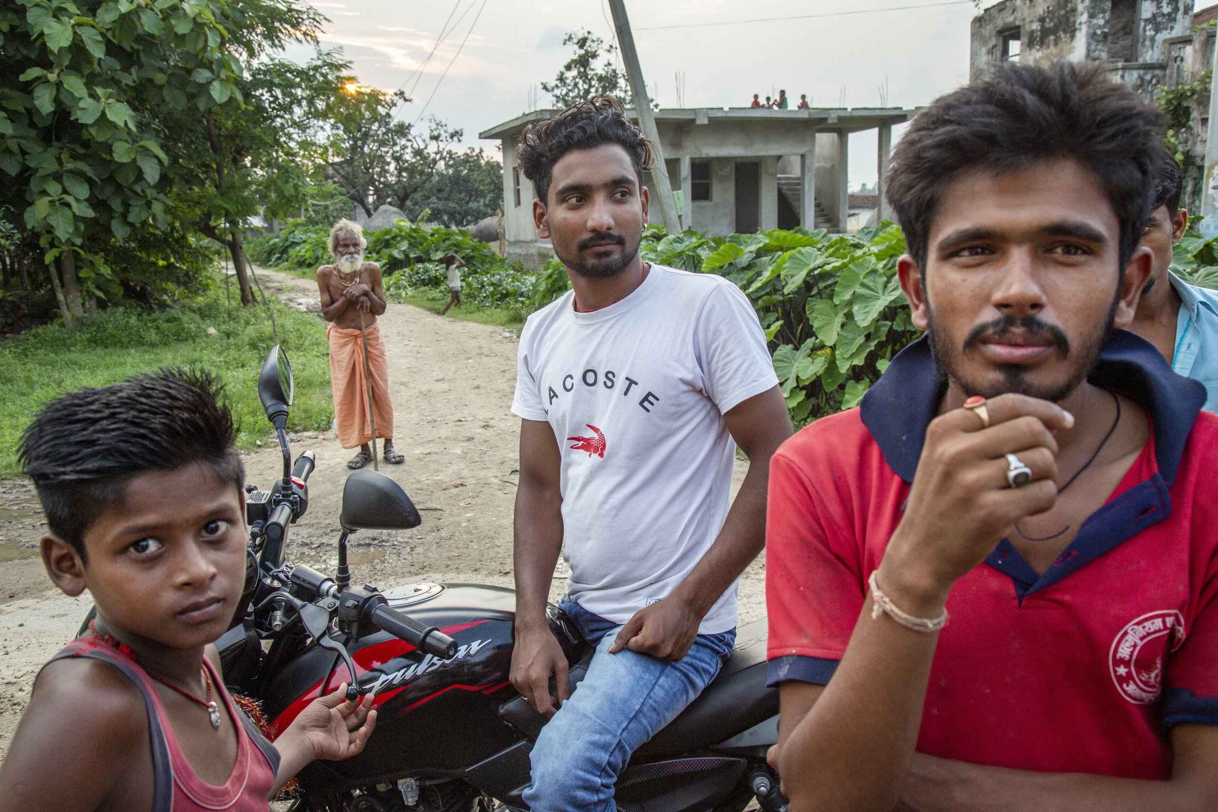  Nepali men on motorbikes hang out in the village of Nagrain 9, in the Ghodhas District outside of Janakpur, Nepal on June 30, 2022. 