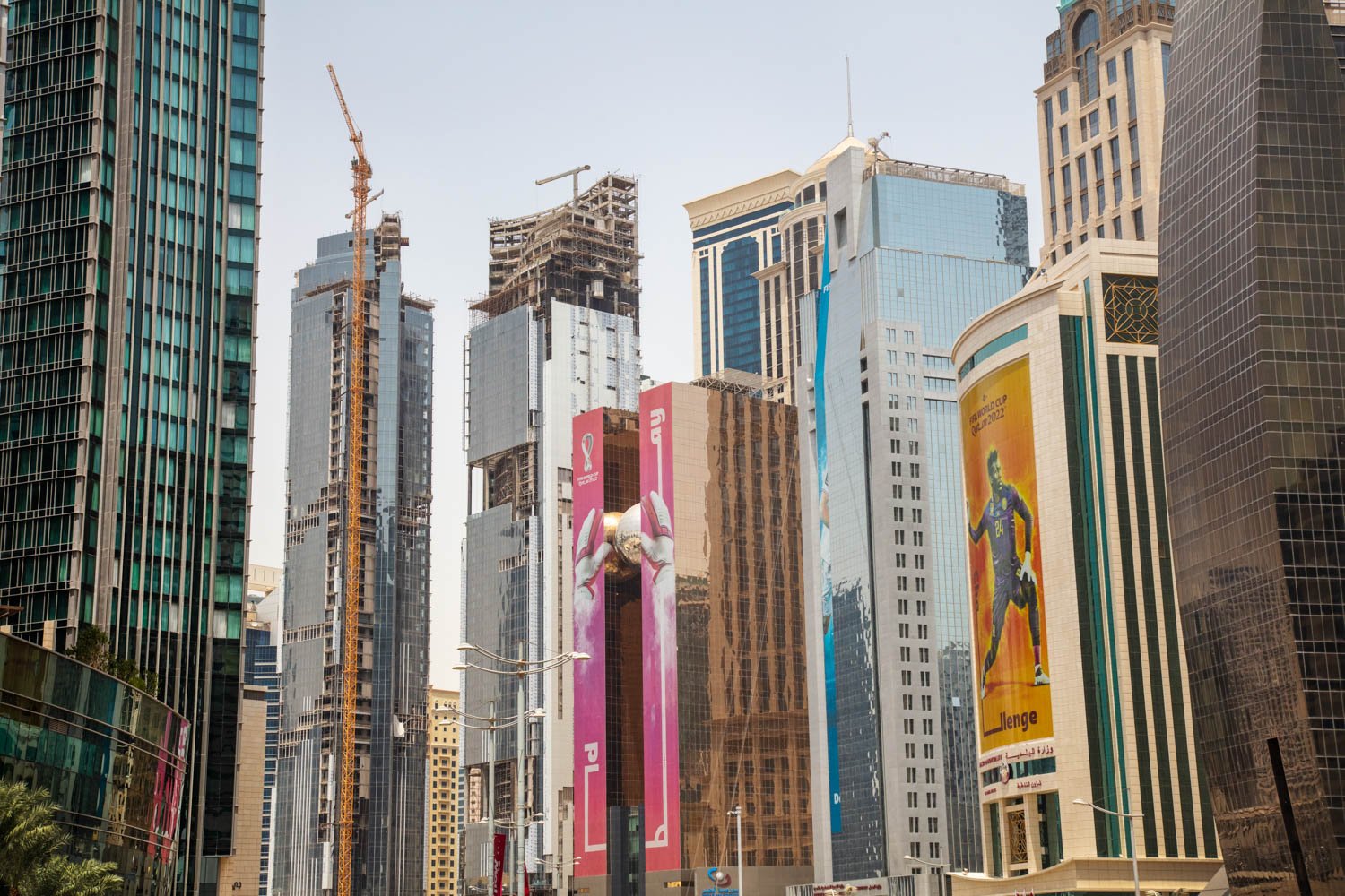  Views of downtown Doha, Qatar with prominent World Cup billboards plastered on modern skyscrapers on August 16, 2022. Tall luxury buildings are under construction.  
