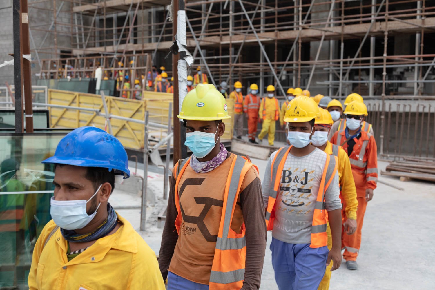  Workers at a construction site in Doha line up to get into buses to head to their sleeping quarters in order to rest during the mid-day heat on August 17, 2022. 