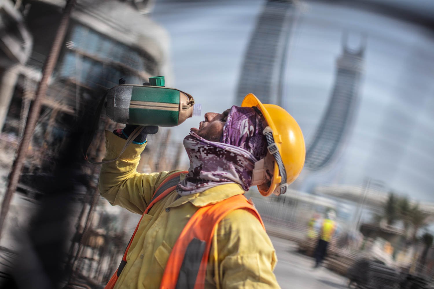  A worker drinks water at a construction site in Lusail City, Qatar on August 18, 2022. 